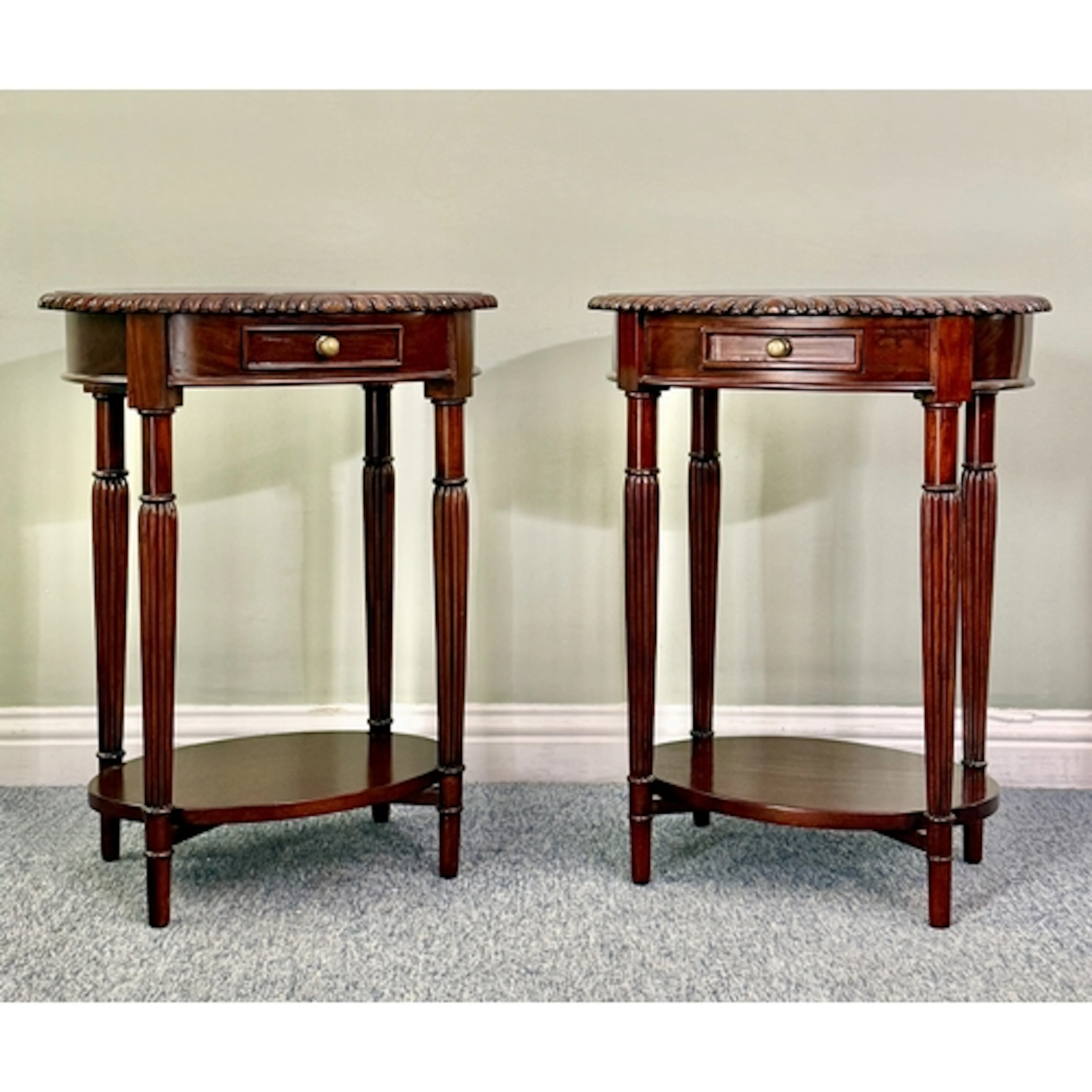 A pair of reproduction mahogany oval lamp or occasional tabl...