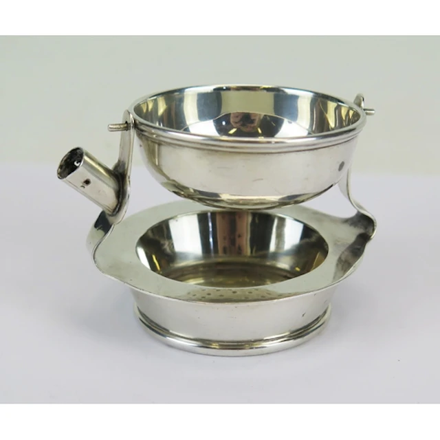 An Art Deco period tilting tea strainer with drip tray, make...