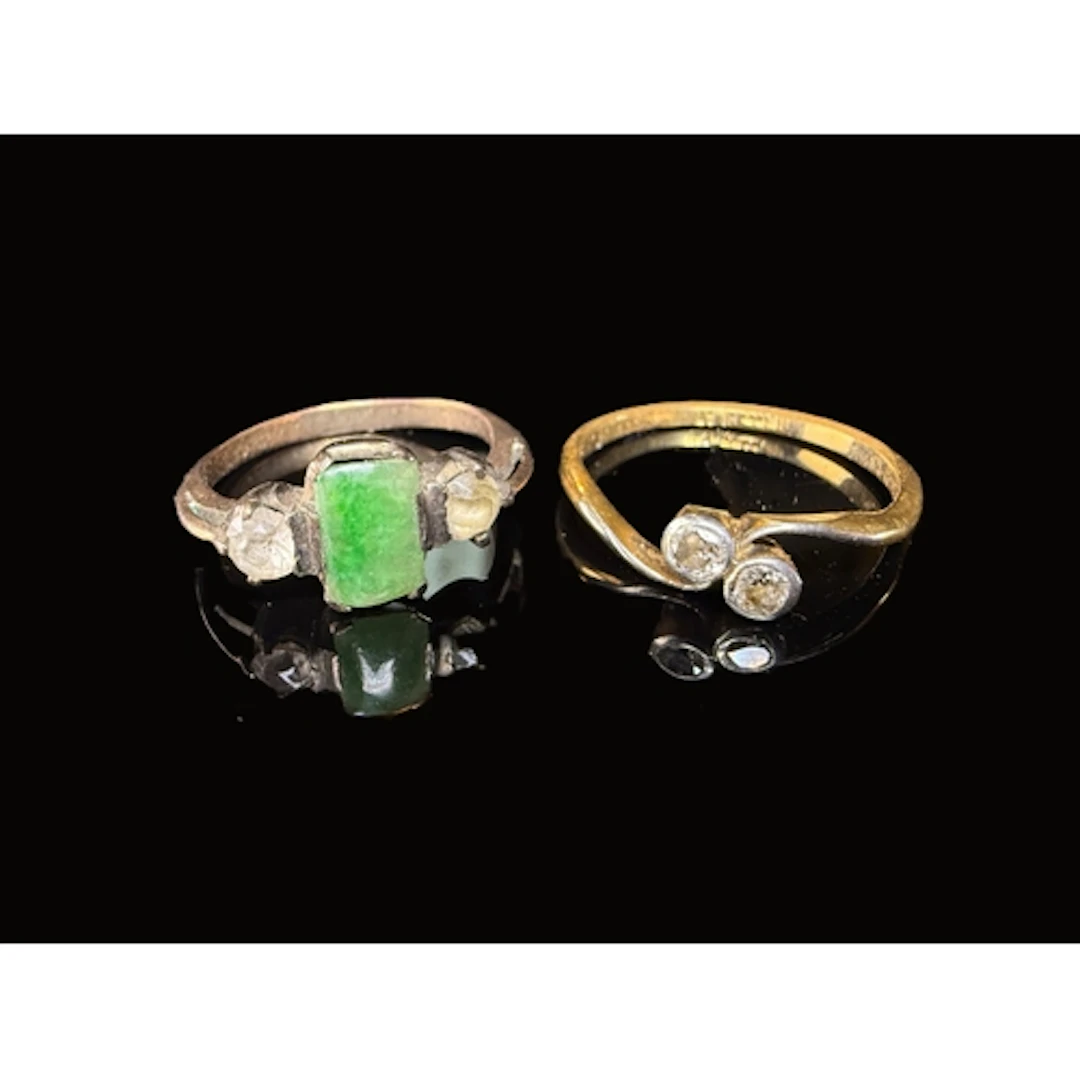A yellow metal cross over engagement ring set with two diamo...