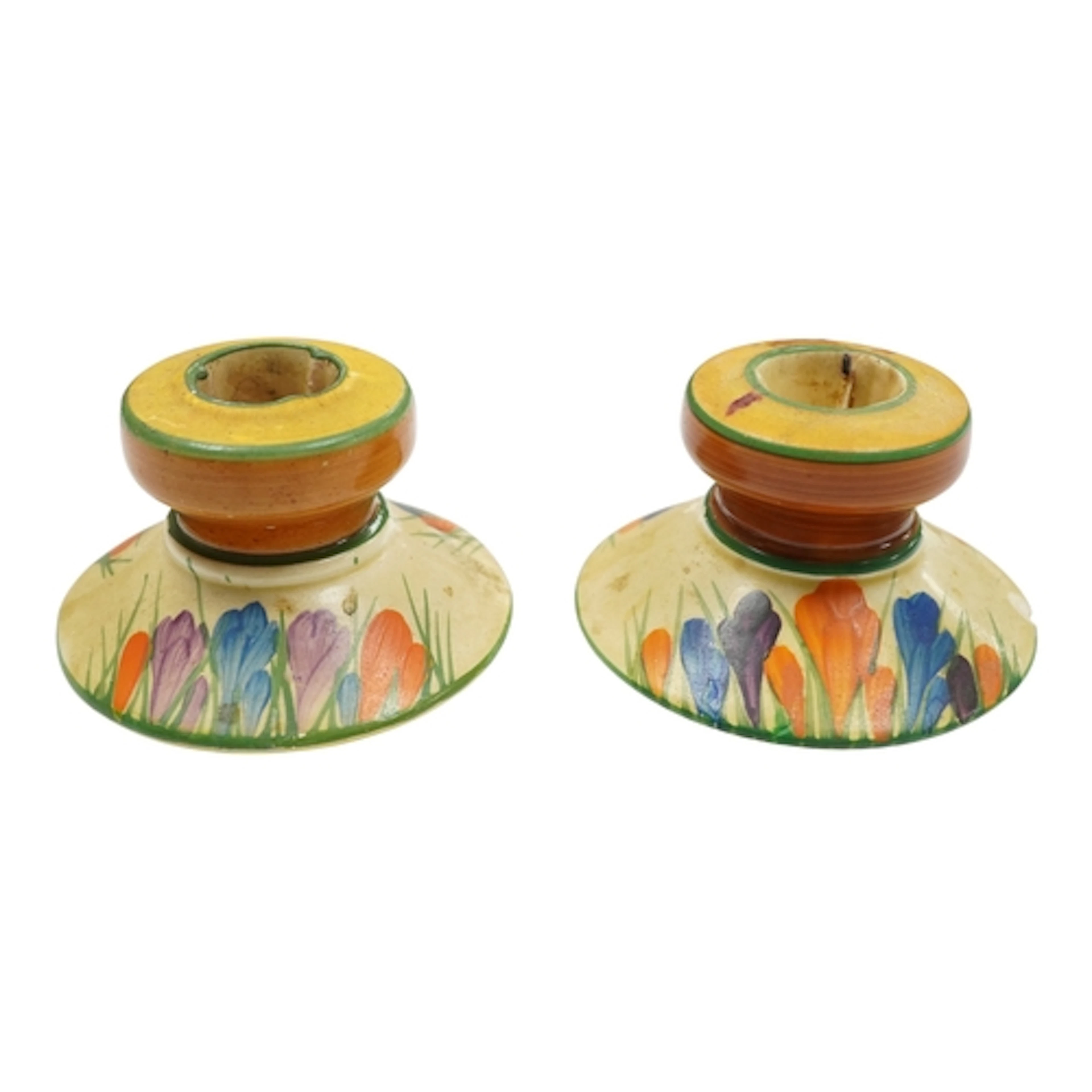 A pair of Clarice Cliff crocus pattern dwarf candlesticks, s...
