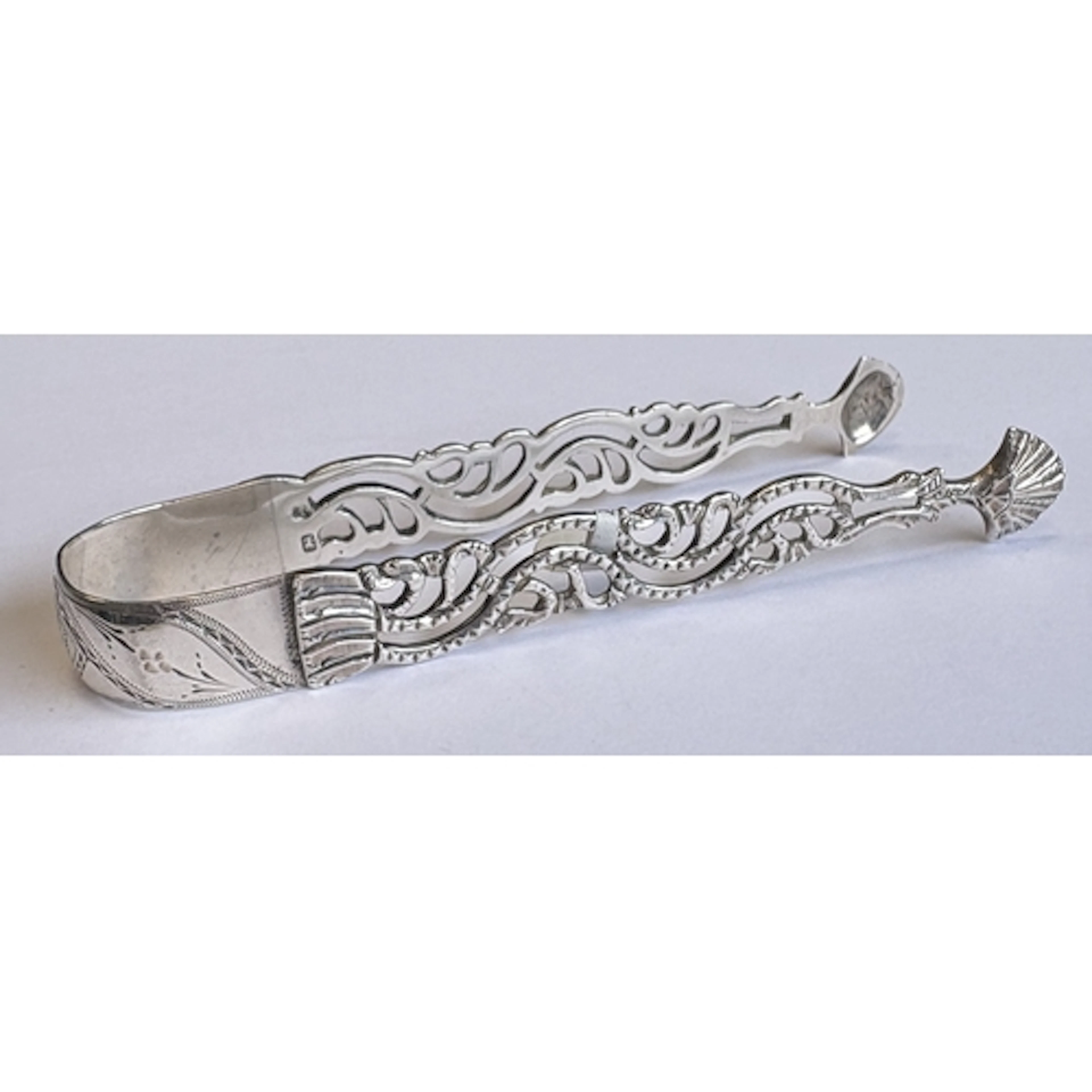 A pair of 18th Century silver sugar tongs with pierced arms ...