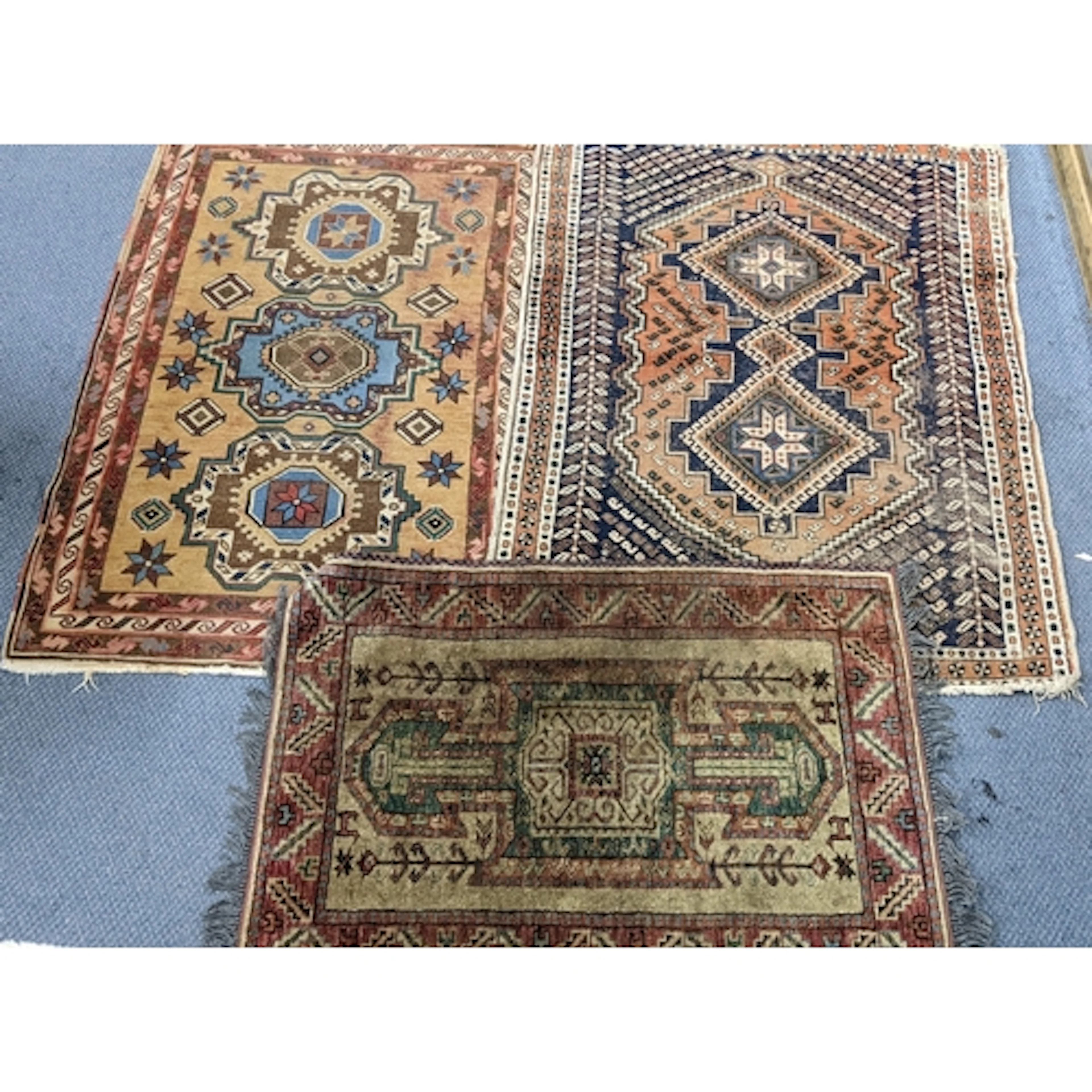 Three rugs to include a hand woven Shiraz rug, having geomet...
