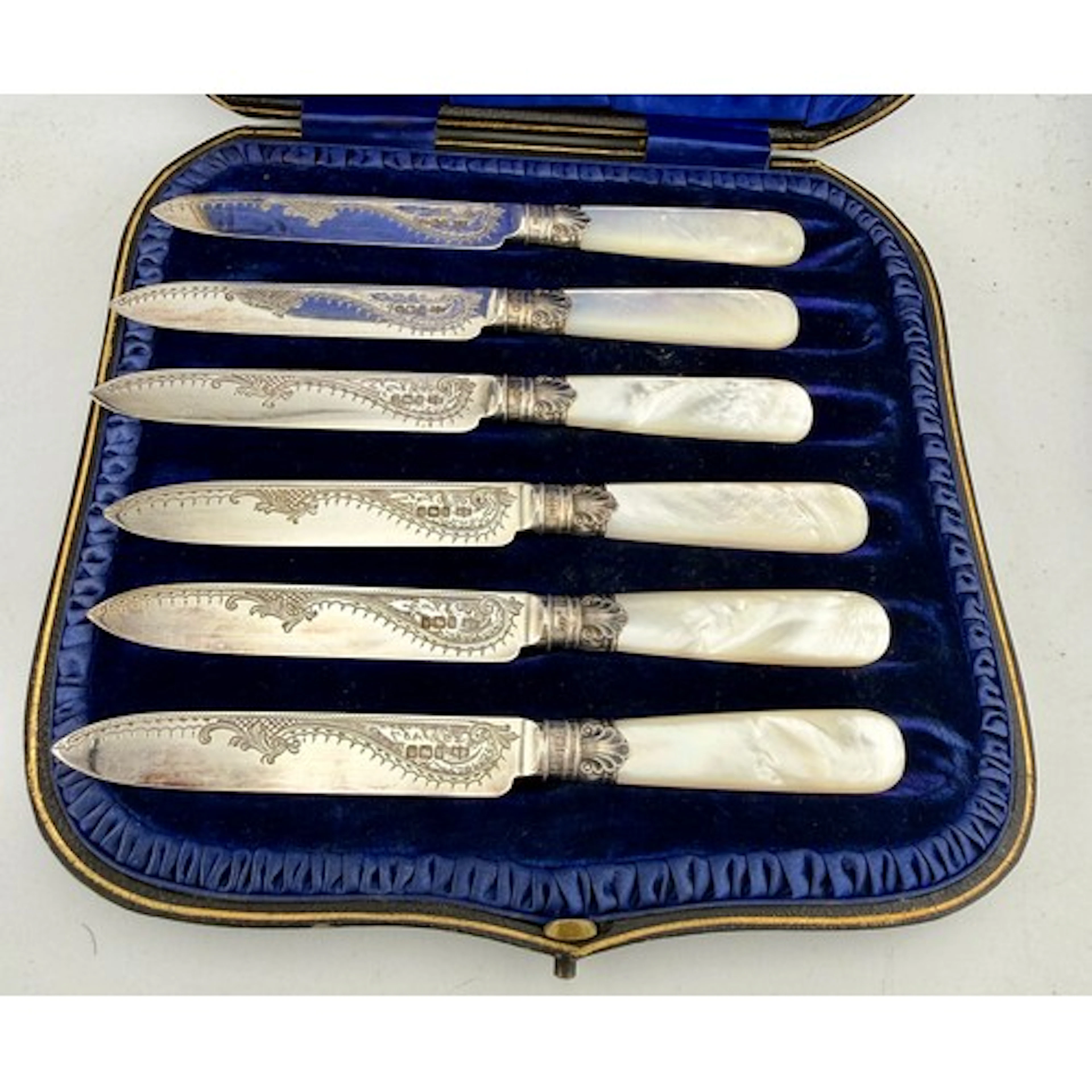 A boxed set of mother of pearl handled silver fruit knives. ...