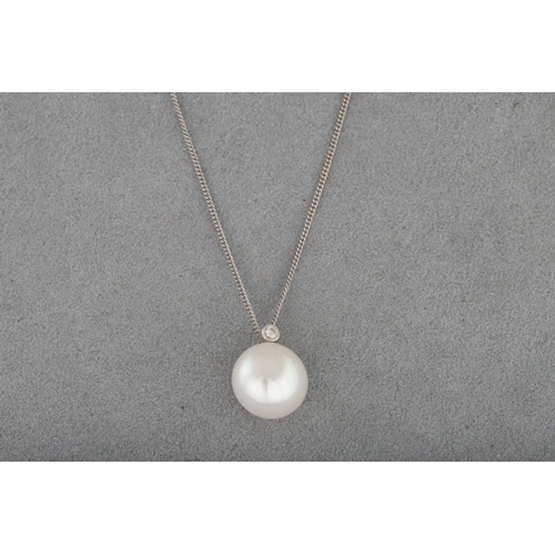 A CULTURED PEARL AND DIAMOND PENDANT, mounted on a 14ct whit...