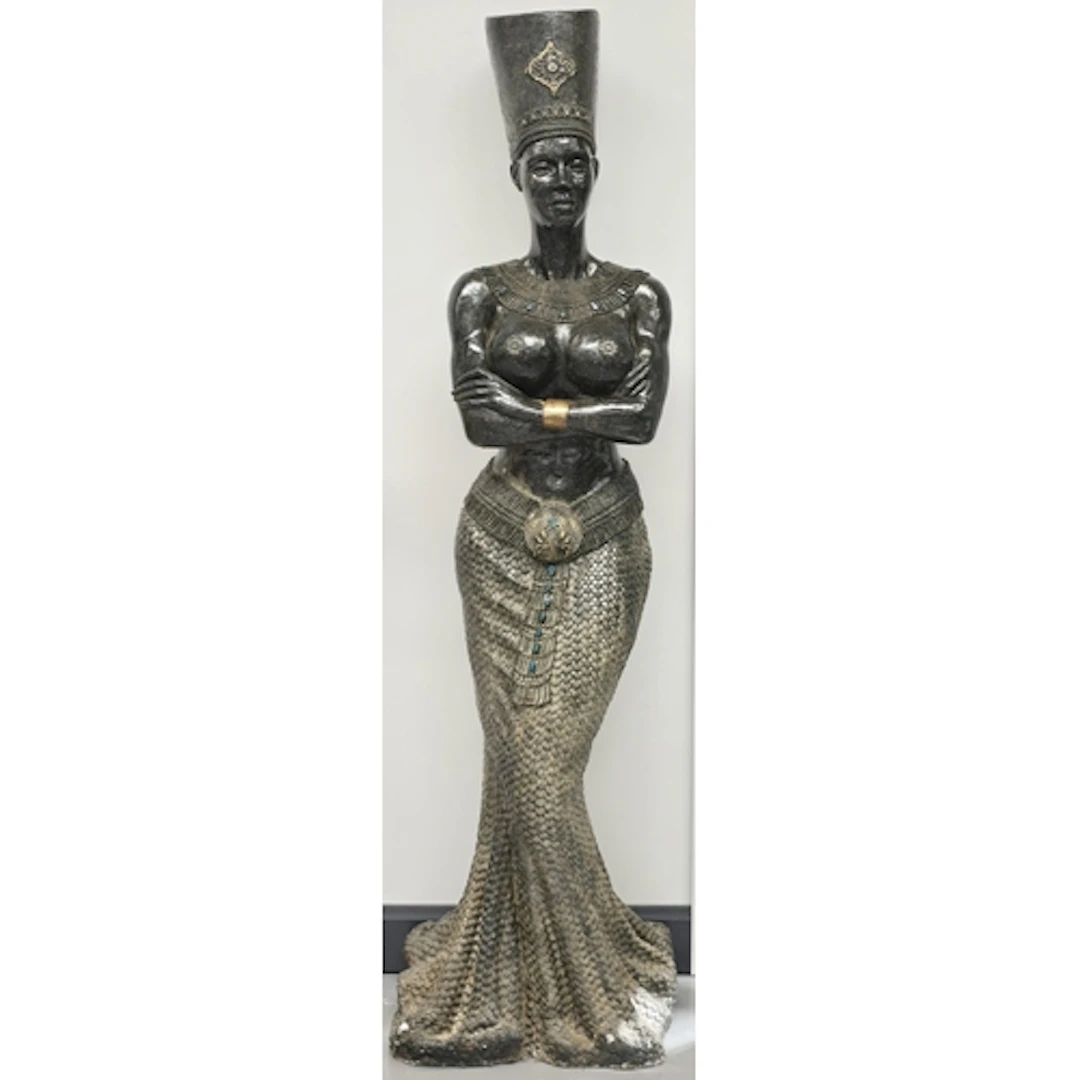 A large decorative floor statue in an Egyptian revival style...