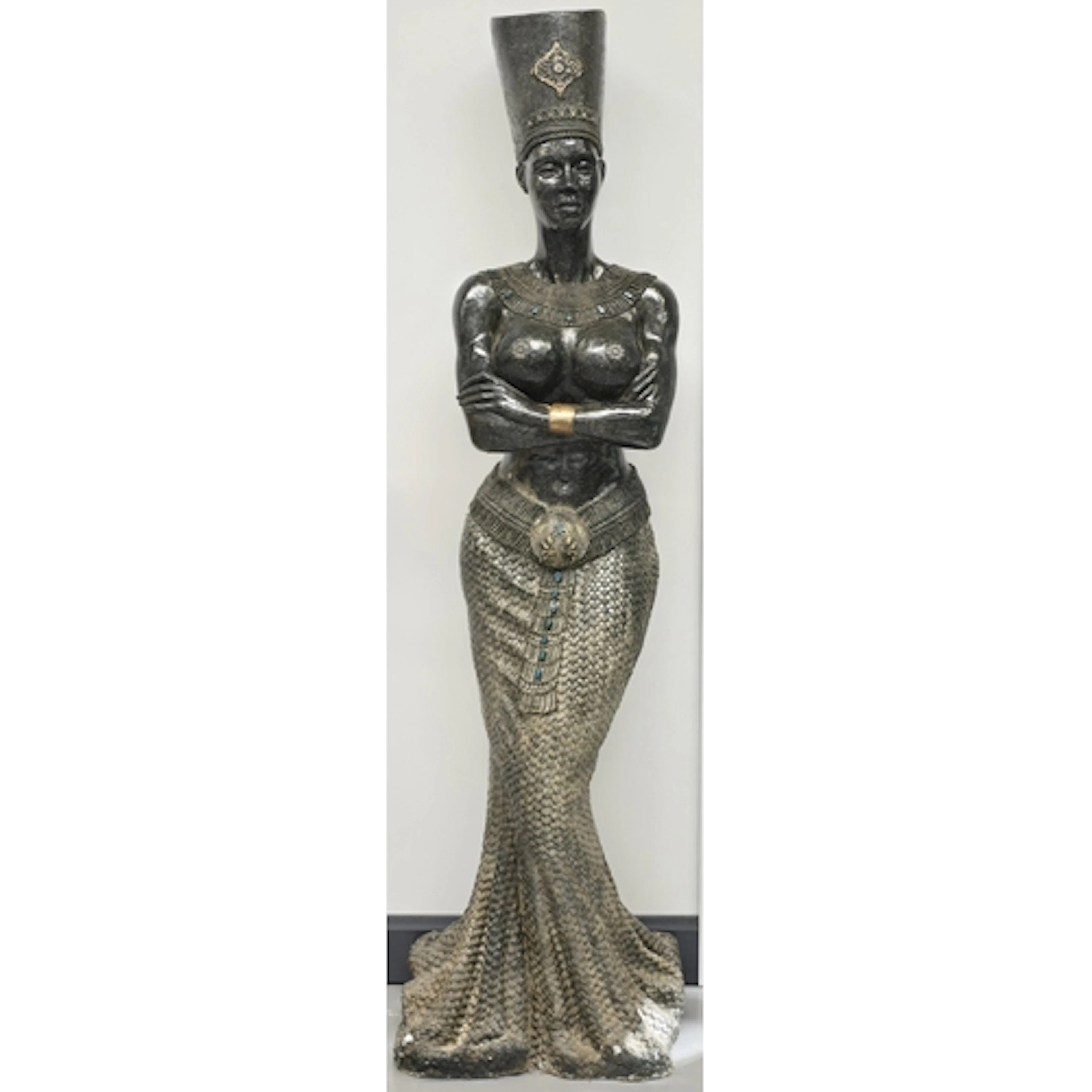 A large decorative floor statue in an Egyptian revival style...