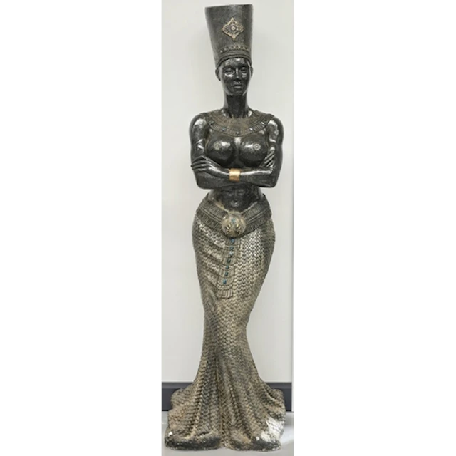 A large decorative floor statue in an Egyptian revival style...