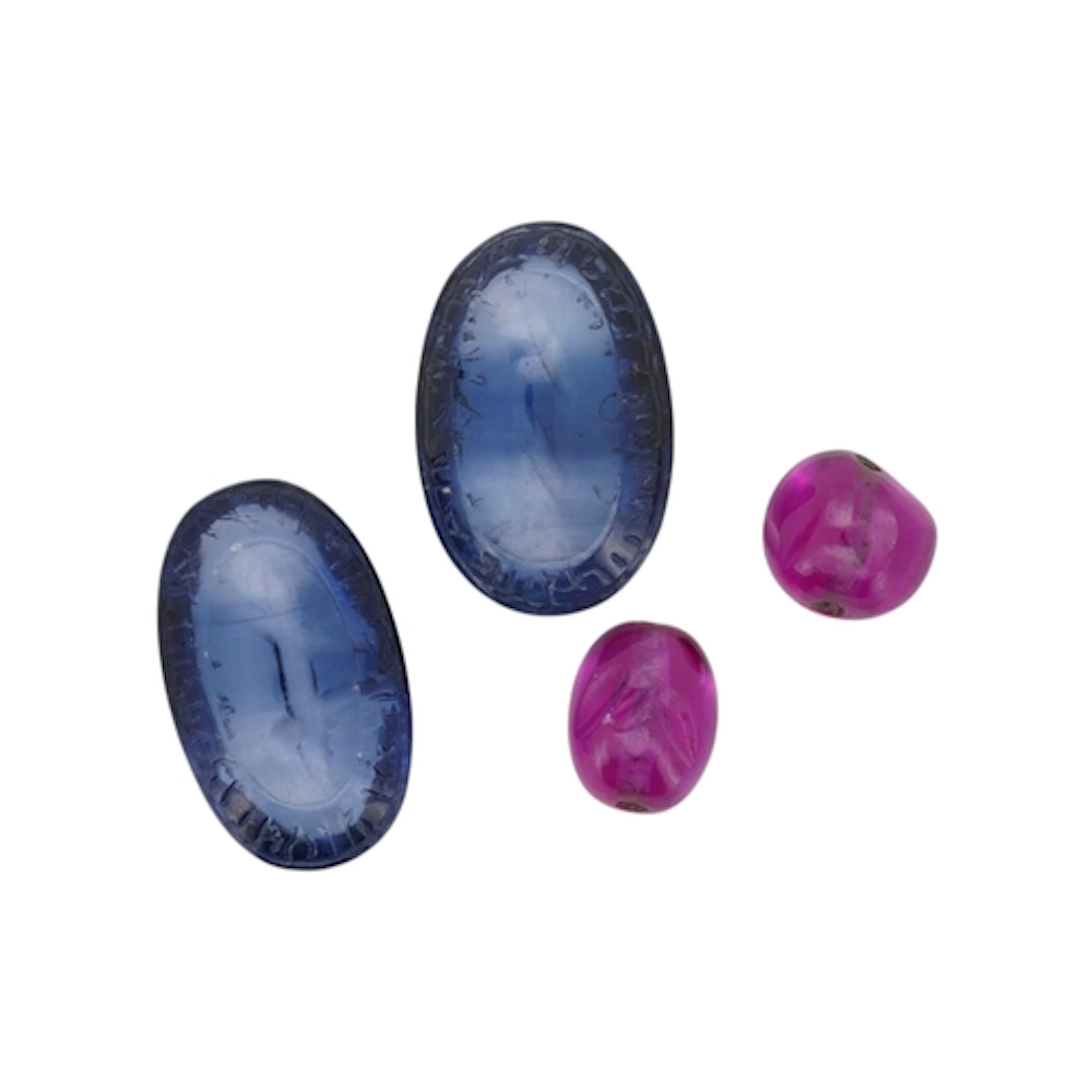 Two carved synthetic sapphire cabochons and two synthetic ru...