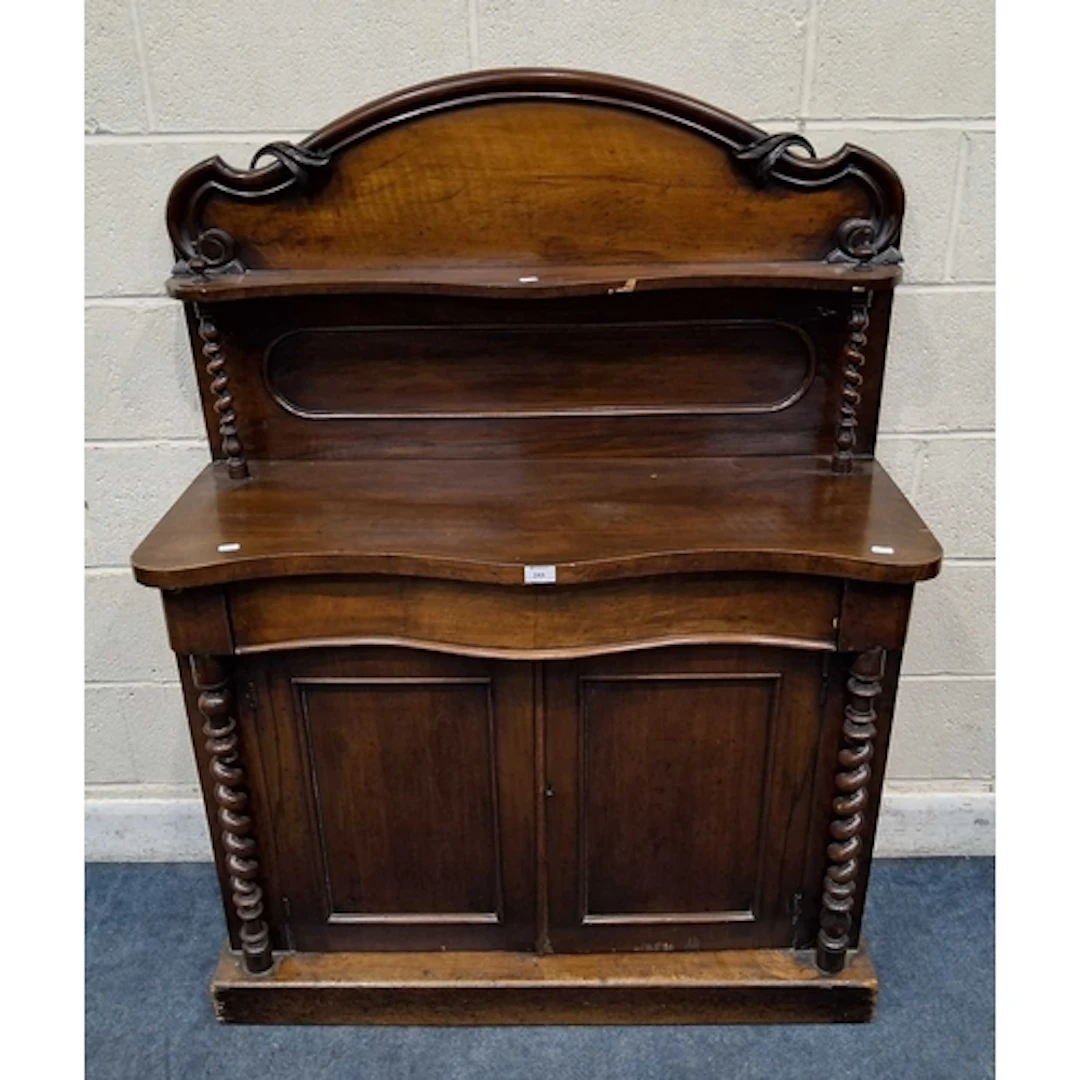 A 19TH CENTURY MAHOGANY SERPENTINE CHIFFONIER, the raised ba...