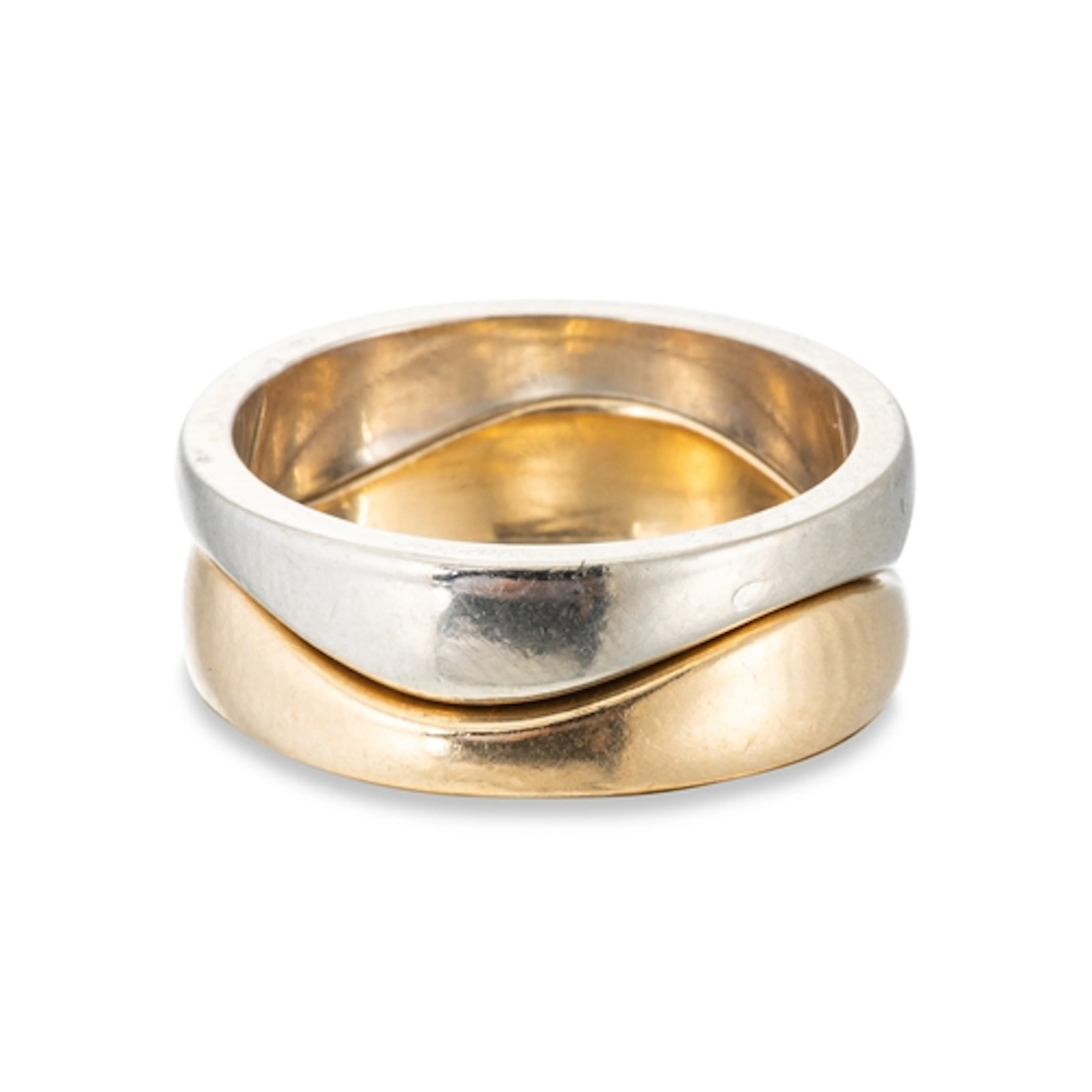 A PAIR OF CARTIER SHAPED RINGS, one in yellow gold and the o...