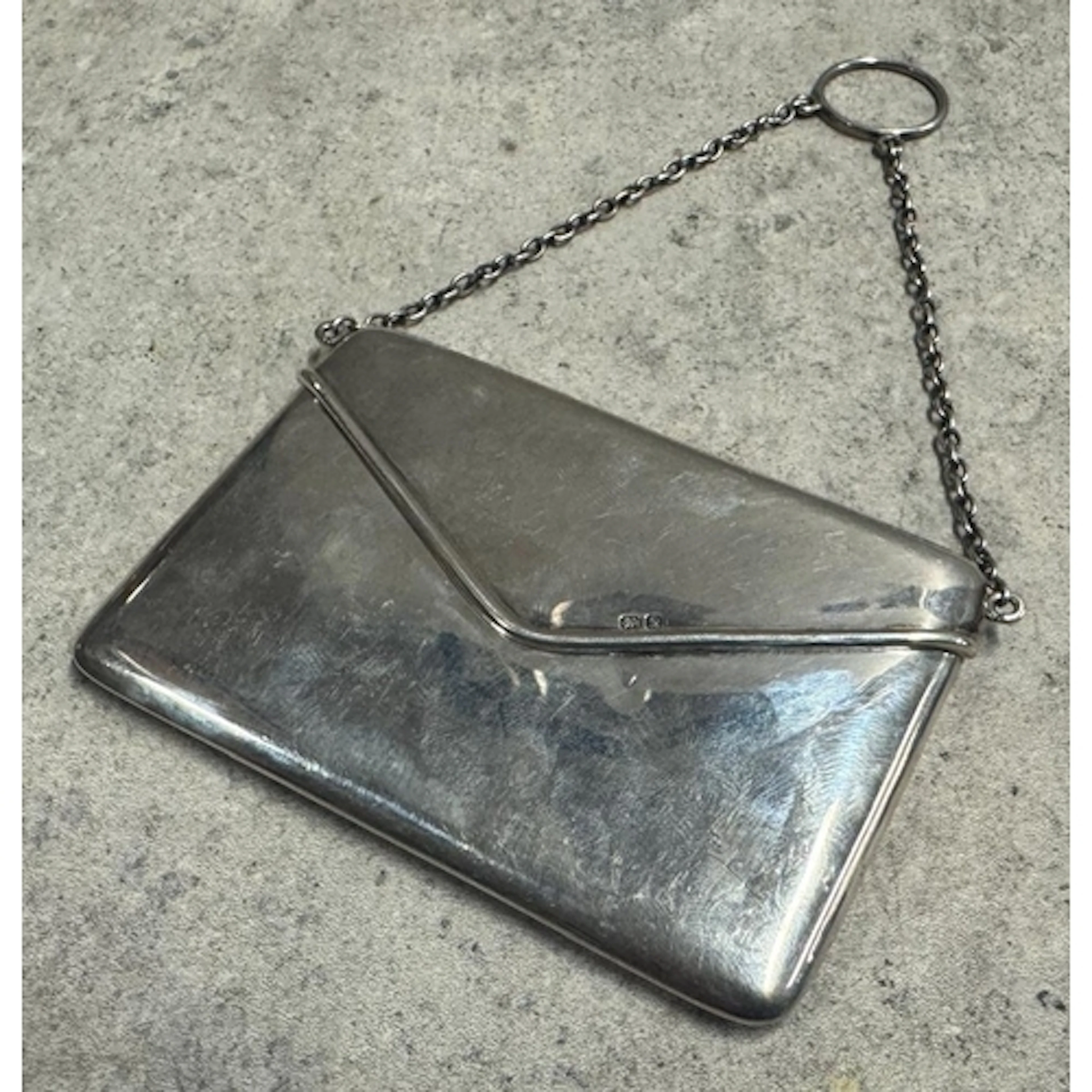 A novelty silver card case in the form of an envelope. Chest...
