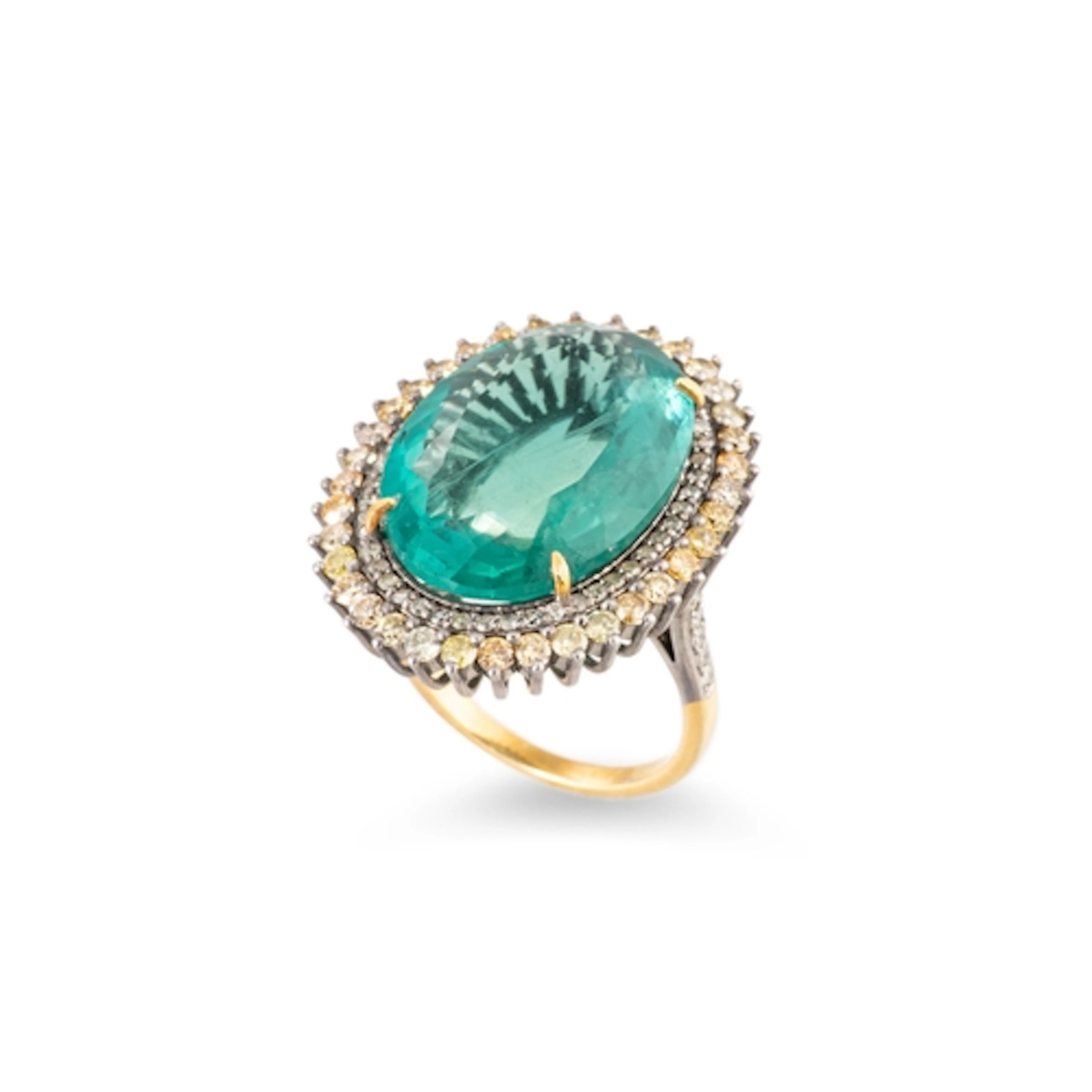 A FLUORITE AND DIAMOND CLUSTER RING, the oval green fluorite...