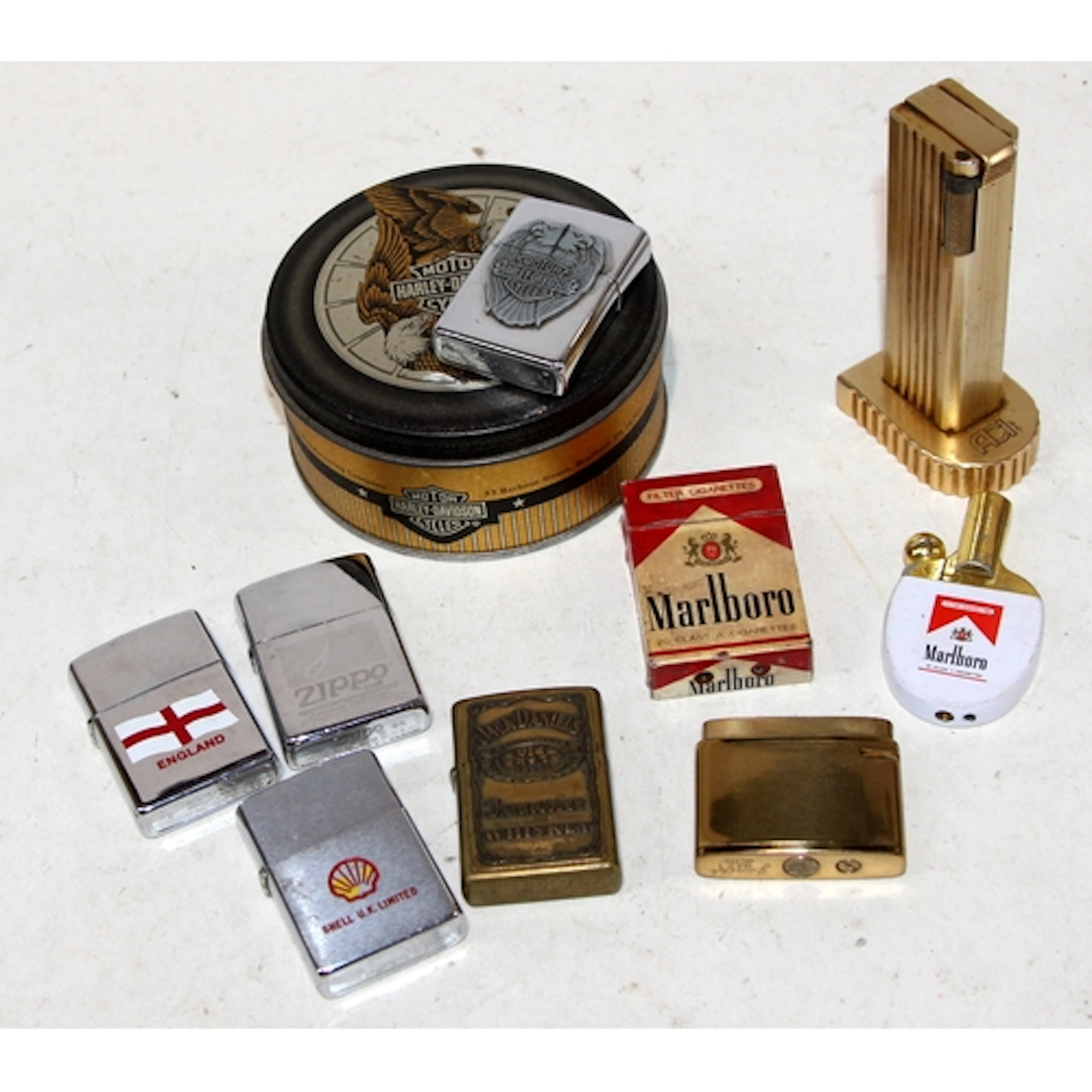 A collection of vintage lighters to include a Harley Davidso...