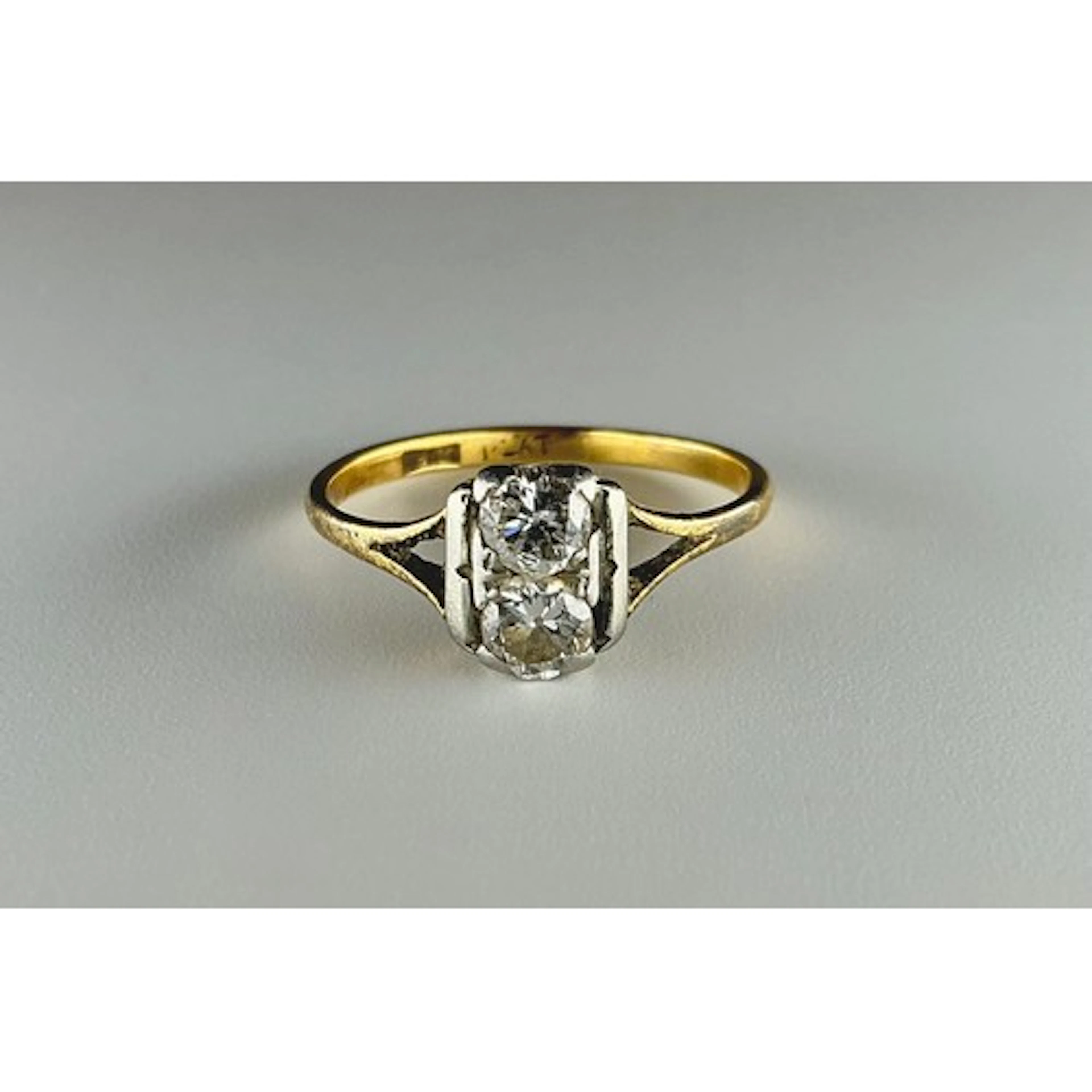 A diamond two stone ring, each round old brilliant cut diamo...