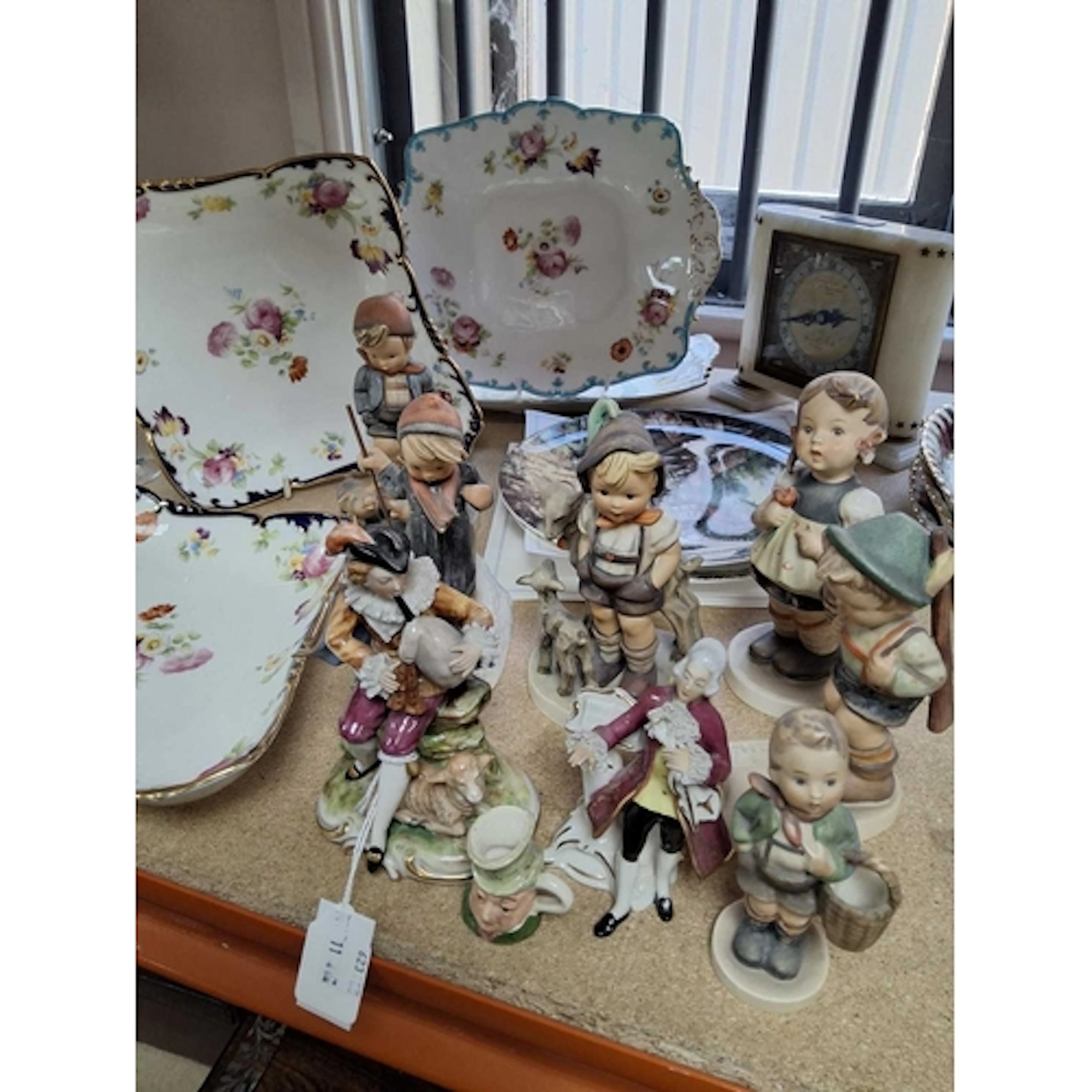 A GROUP OF CERAMICS AND A CLOCK, comprising six Hummel figur...