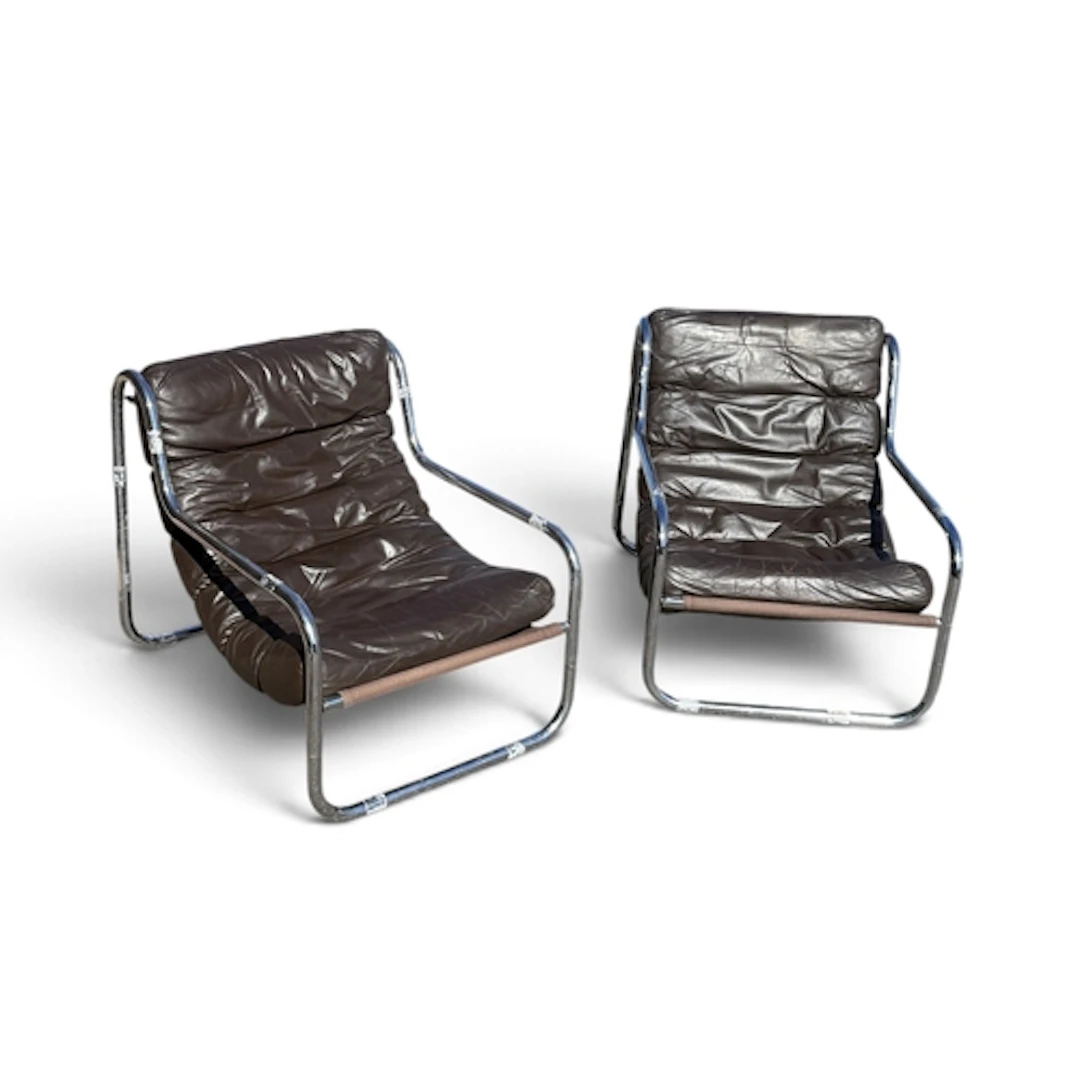 A PAIR OF MID CENTURY TUBULAR CHAIRS With brown leather seat...