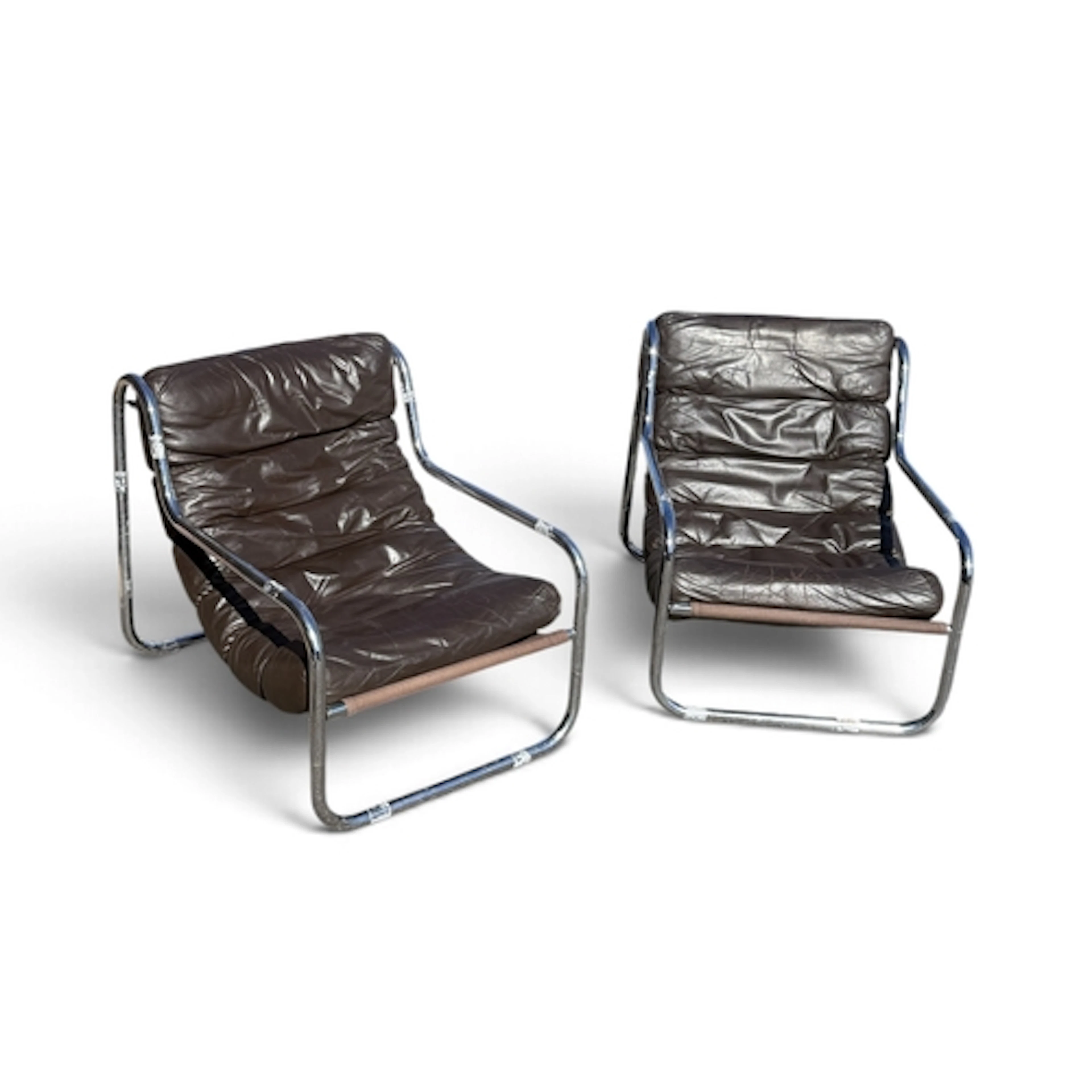 A PAIR OF MID CENTURY TUBULAR CHAIRS With brown leather seat...