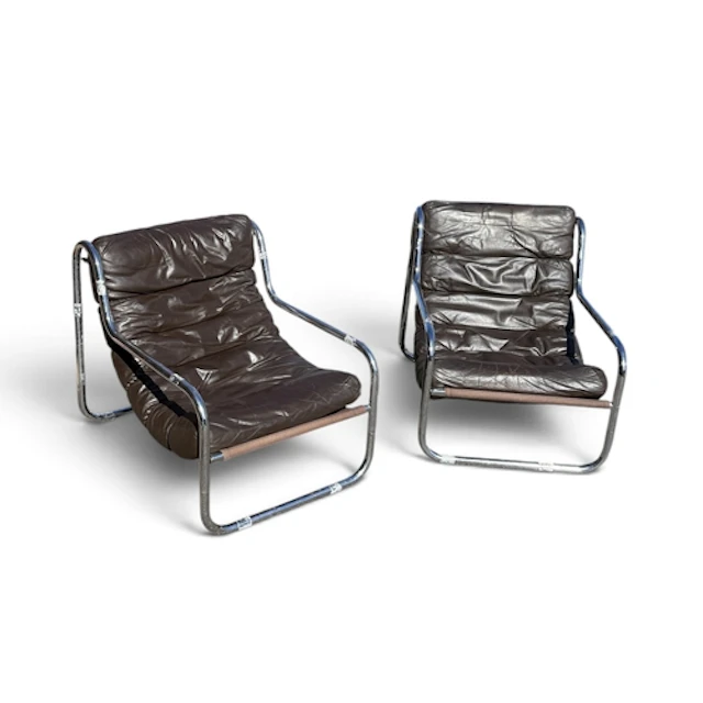 A PAIR OF MID CENTURY TUBULAR CHAIRS With brown leather seat...