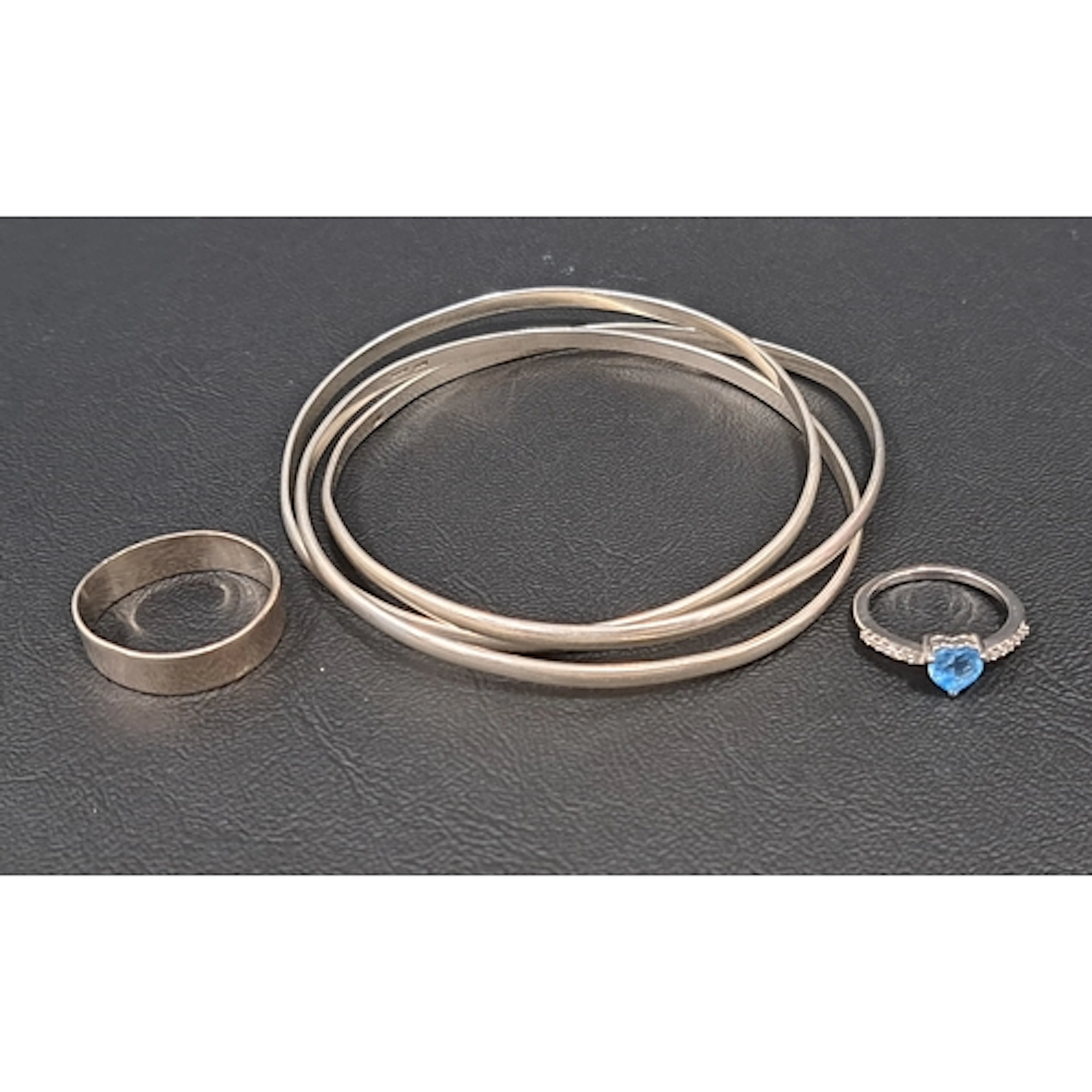 THREE PIECES OF SILVER JEWELLERY comprising a triple entwine...