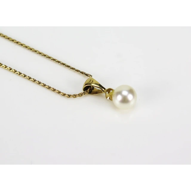A cultured pearl and diamond pendant in a 14K yellow gold se...