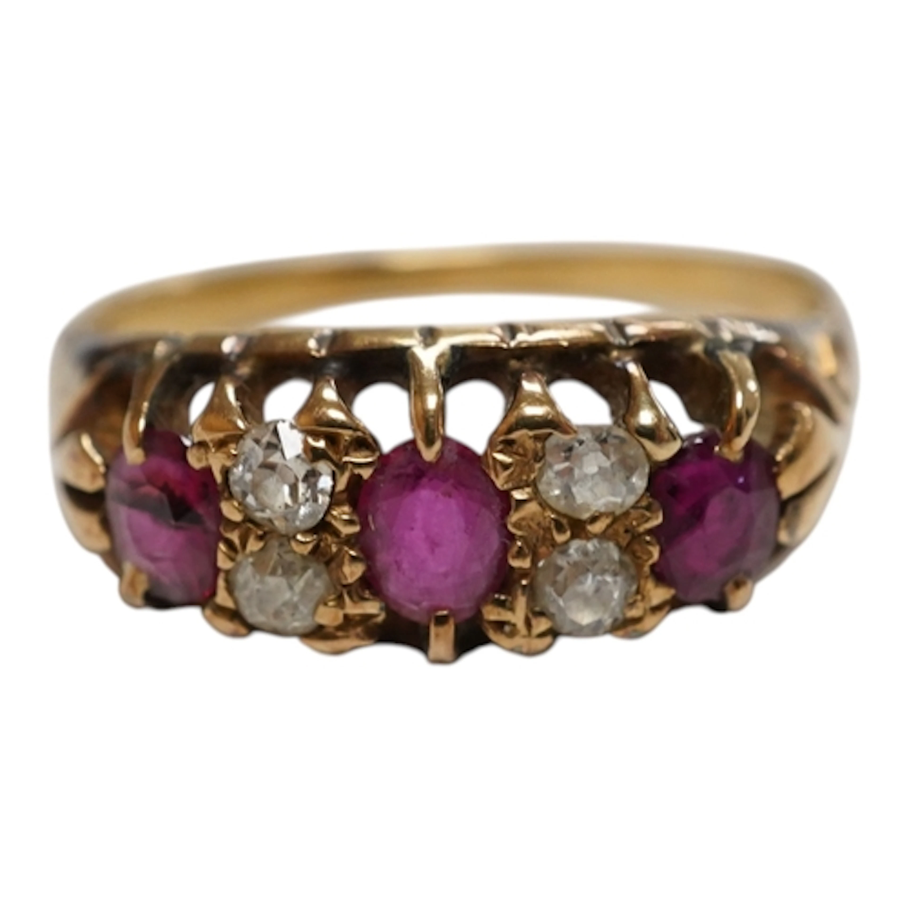 An unmarked yellow metal, three stone ruby and four stone di...