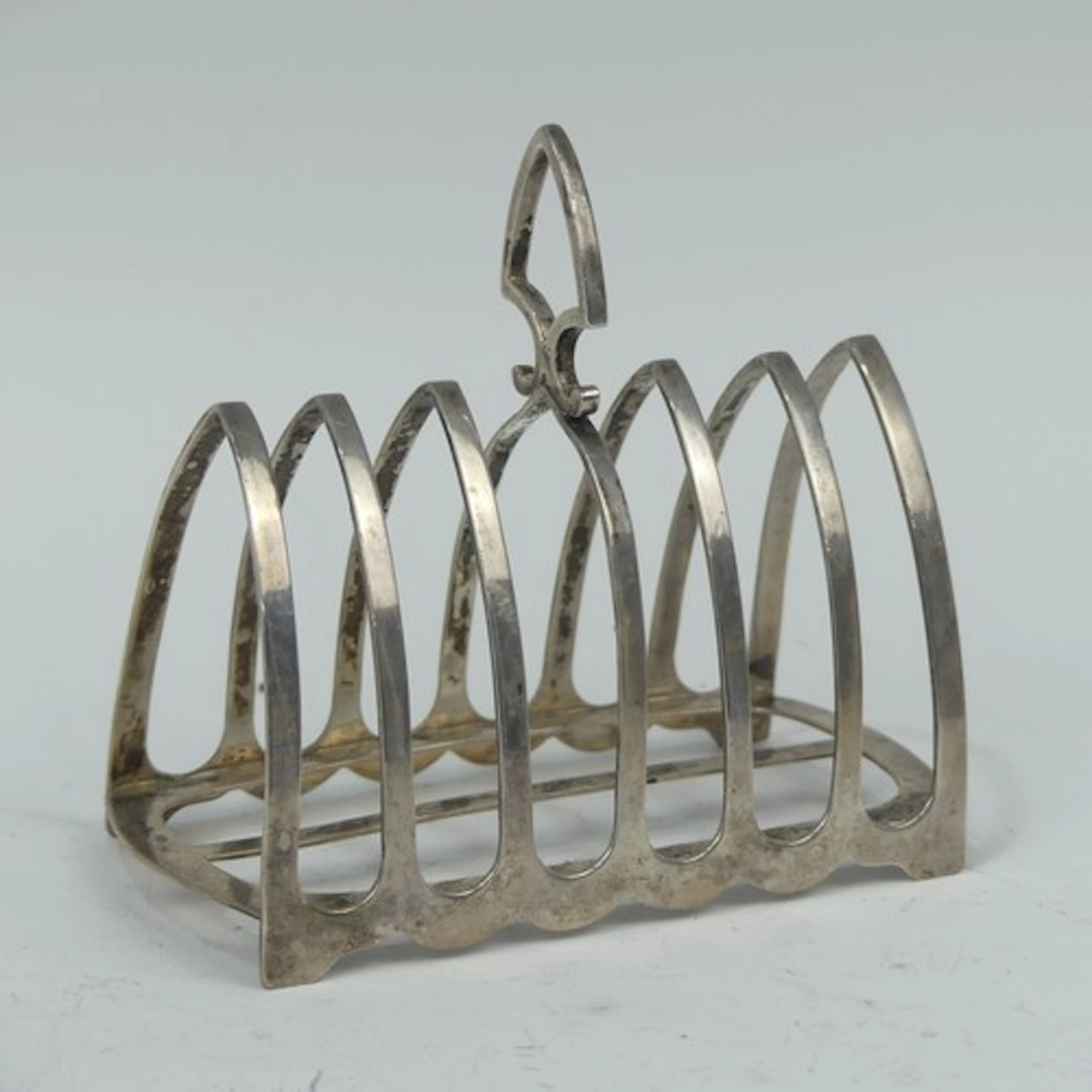 A George V silver seven bar Toast Rack, by Harrison Bro...