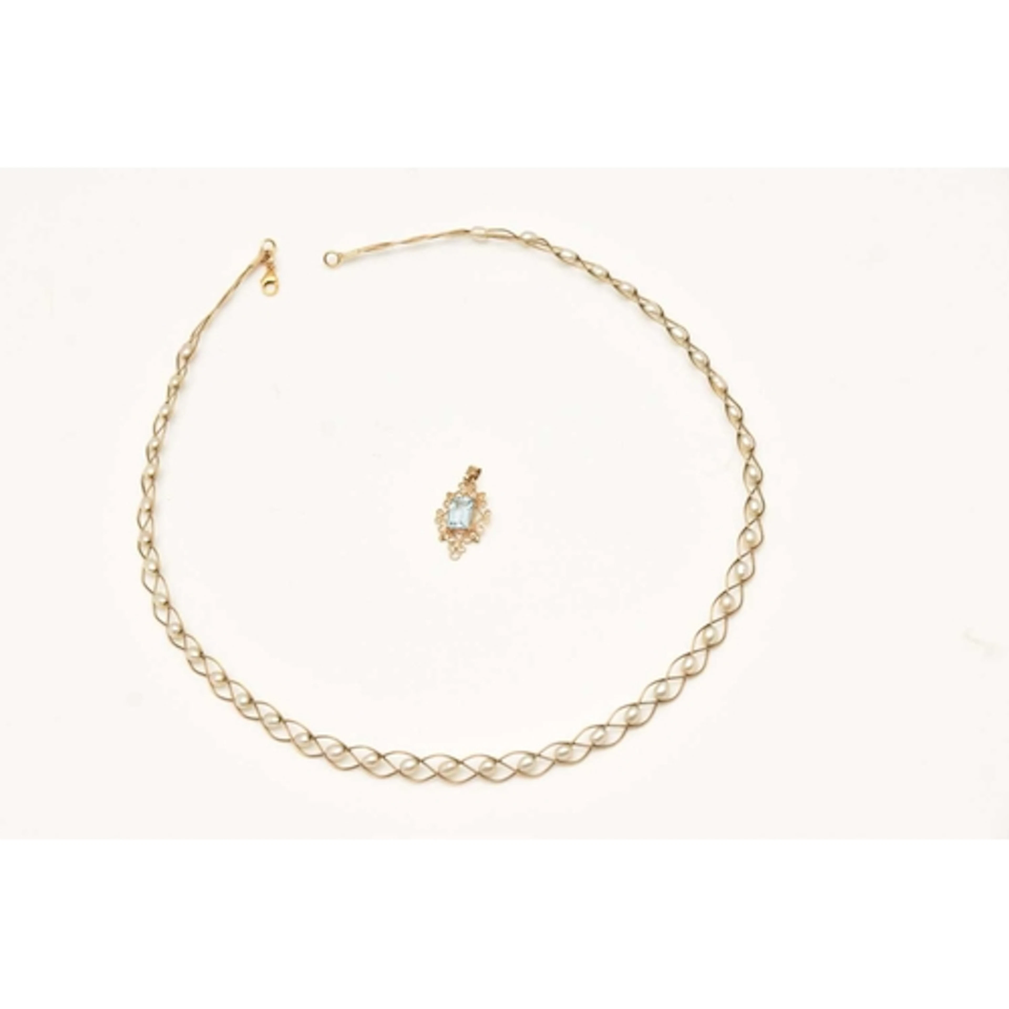 A PENDANT AND NECKLACE, to include a yellow metal open work ...