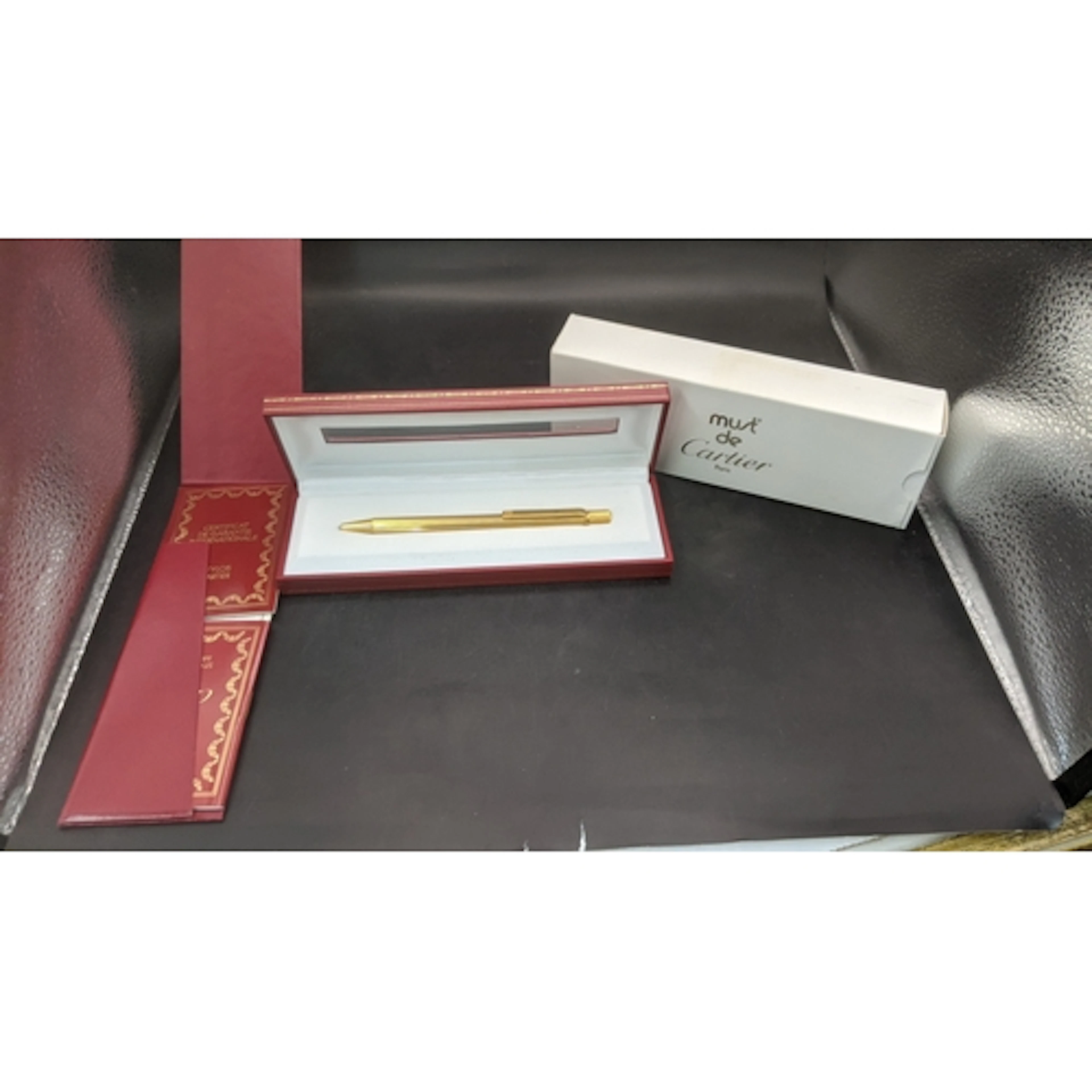 A boxed cartier Santos Sans a Graffe gold plated ballpoint p...