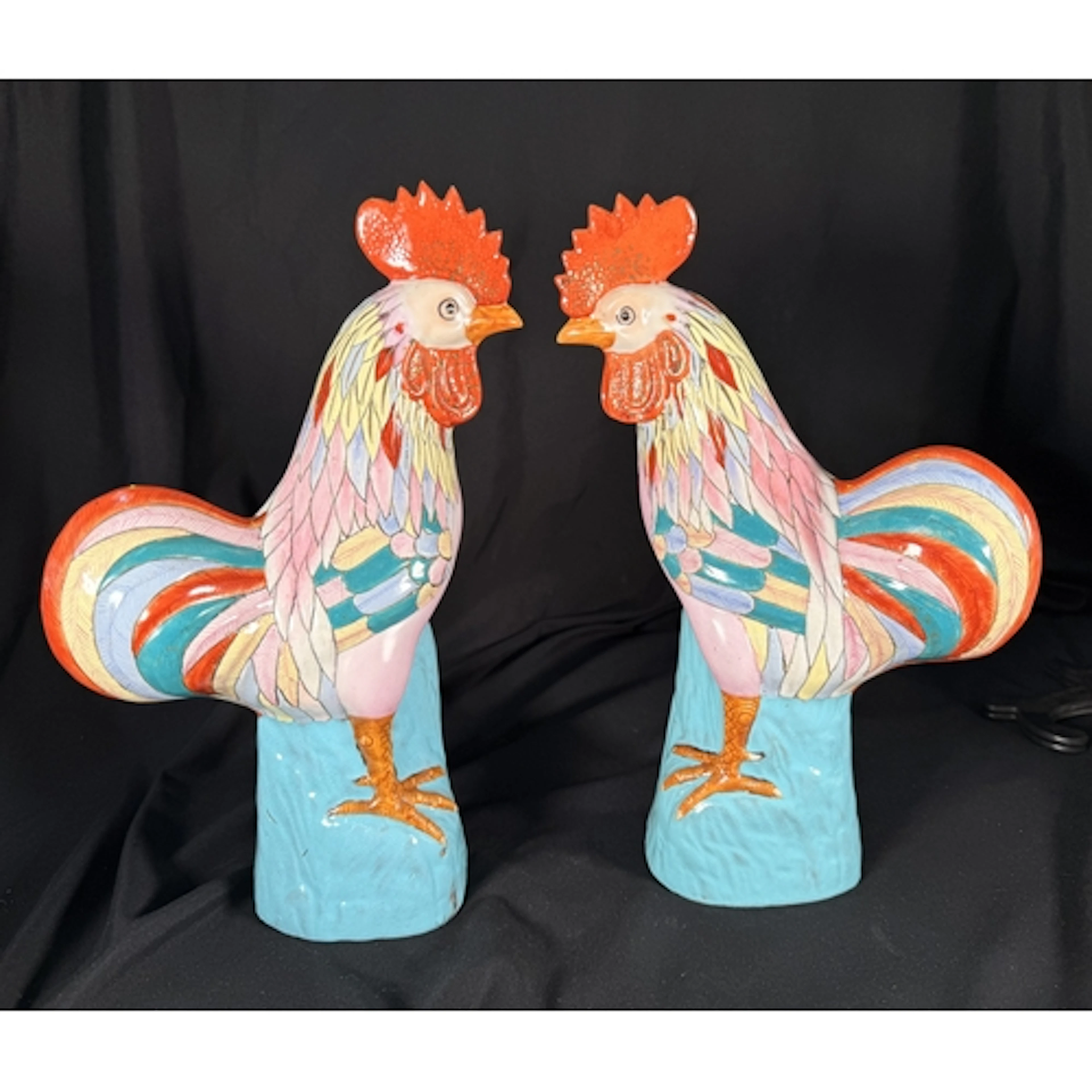 A pair of Chinese porcelain cockerels with brightly colored ...
