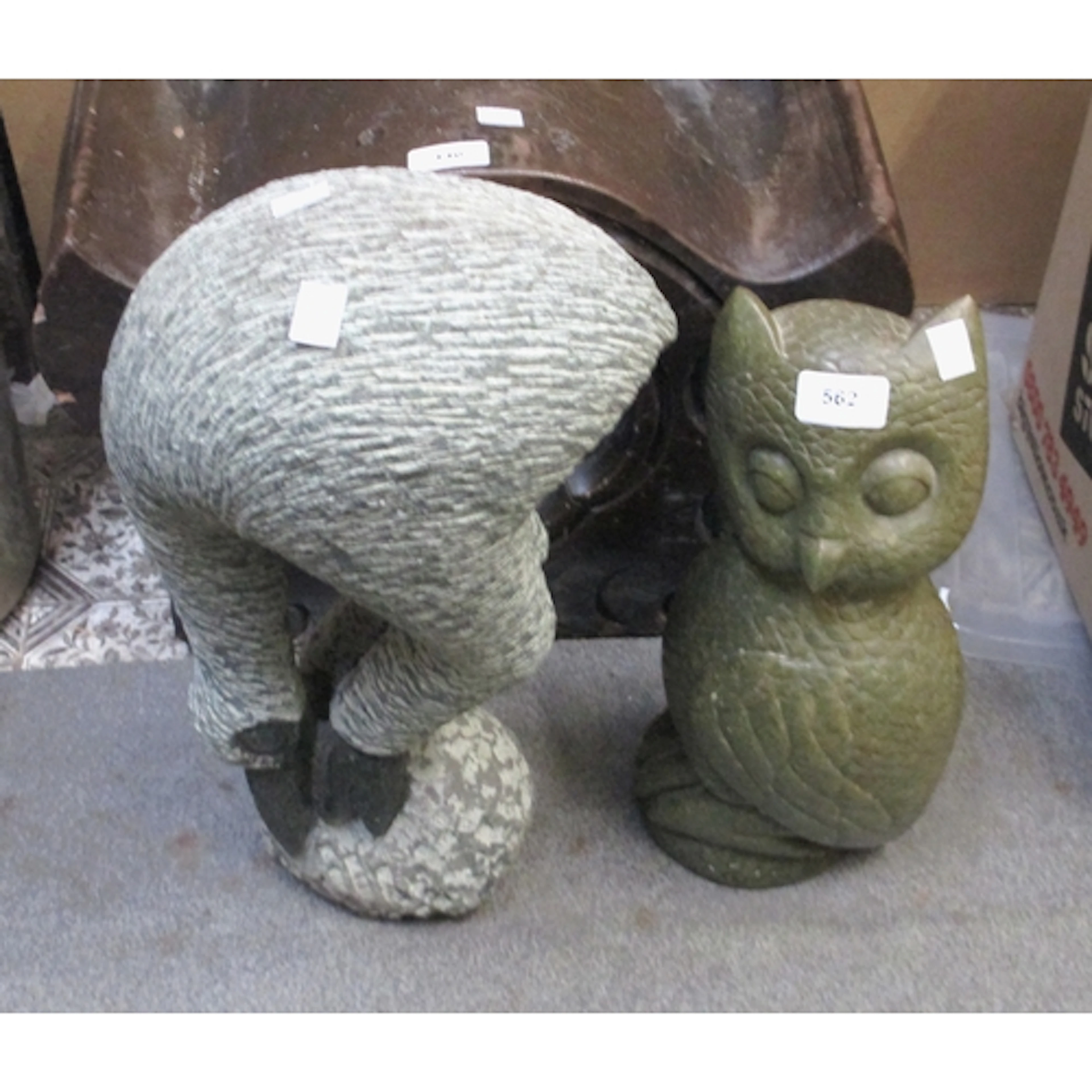 Carved serpentine figure of a stylised bird perched on a roc...