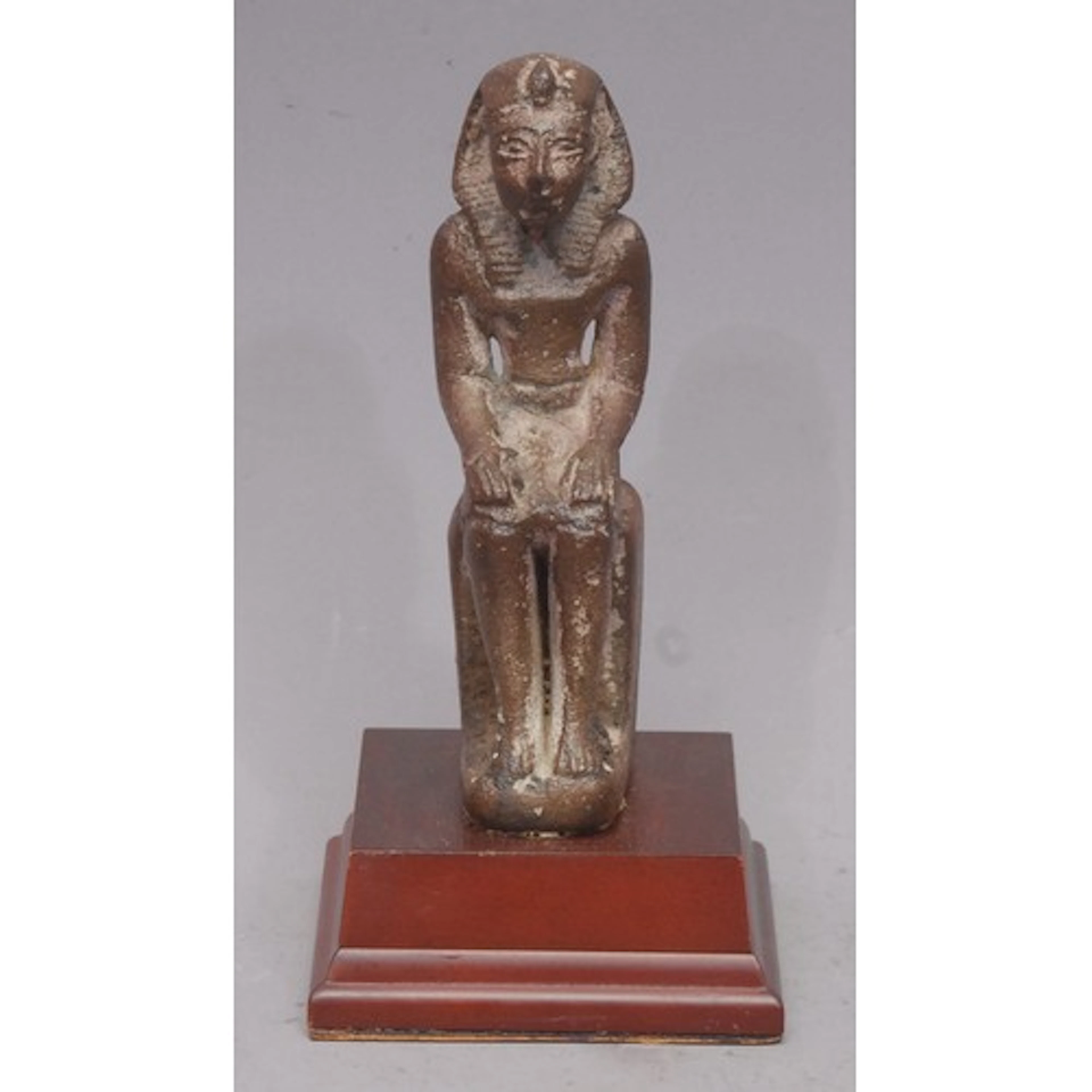 Antiquities - an Egyptian stoneware seated figure, possibly ...