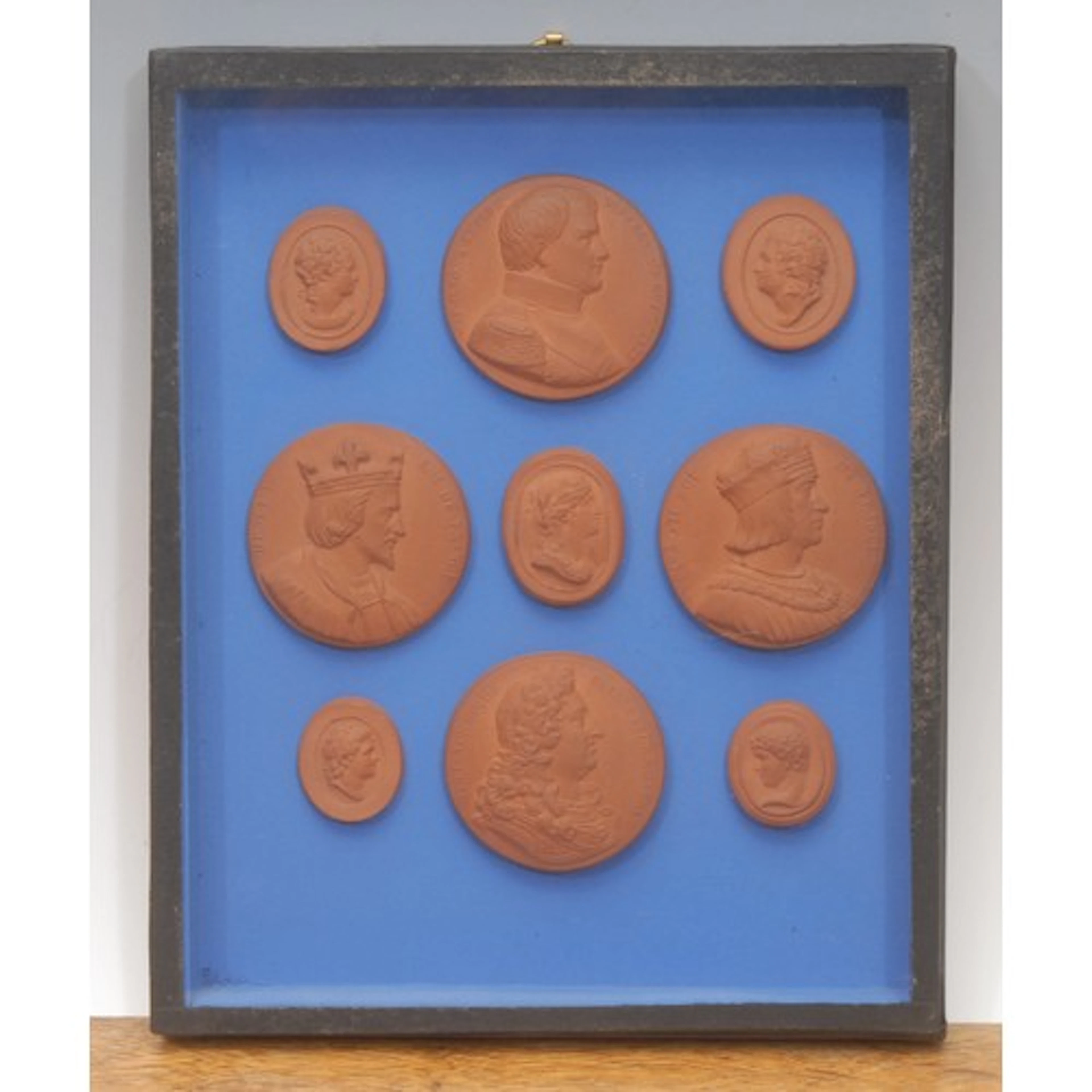 An arrangement of nine terracotta cameo impressions, in the ...