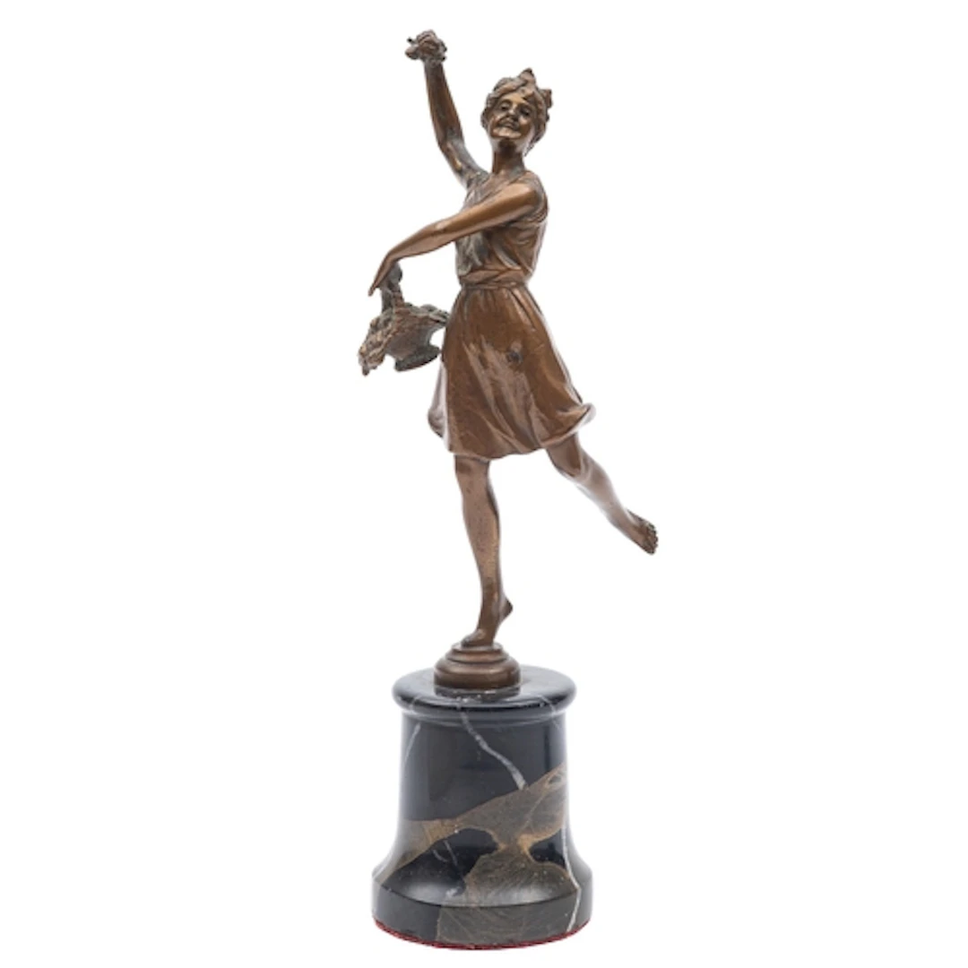 A Continental cold painted bronze model of a flower girl, ci...