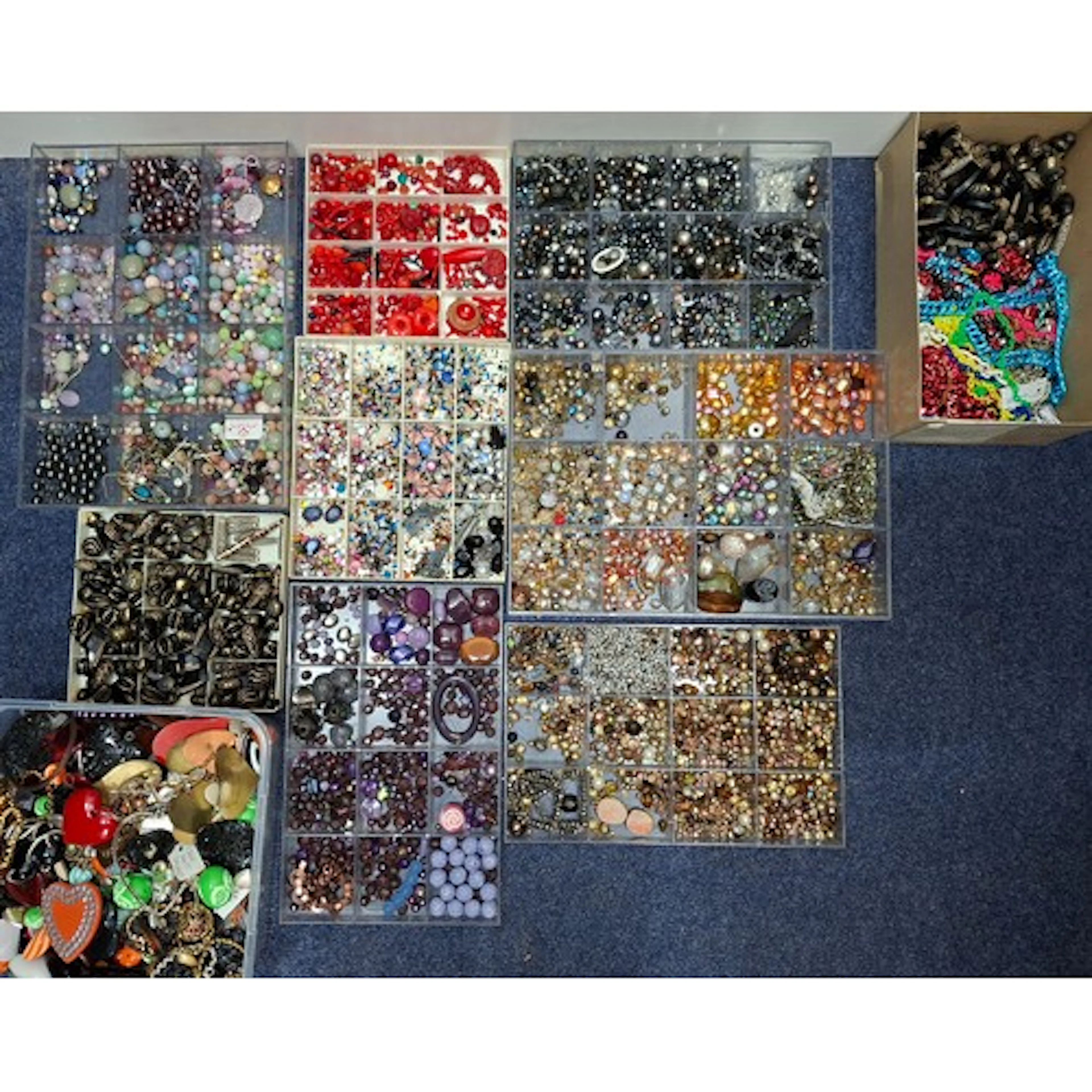 Fifteen trays and 2 boxes of loose beads and broken jeweller...