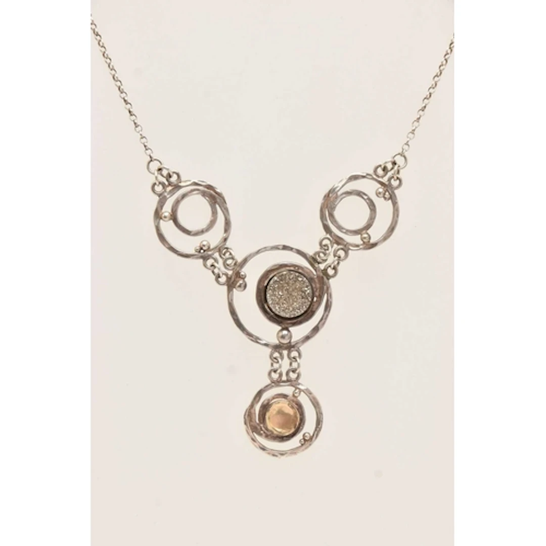 A WHITE METAL ABSTRACT PENDANT NECKLACE, circular open work ...