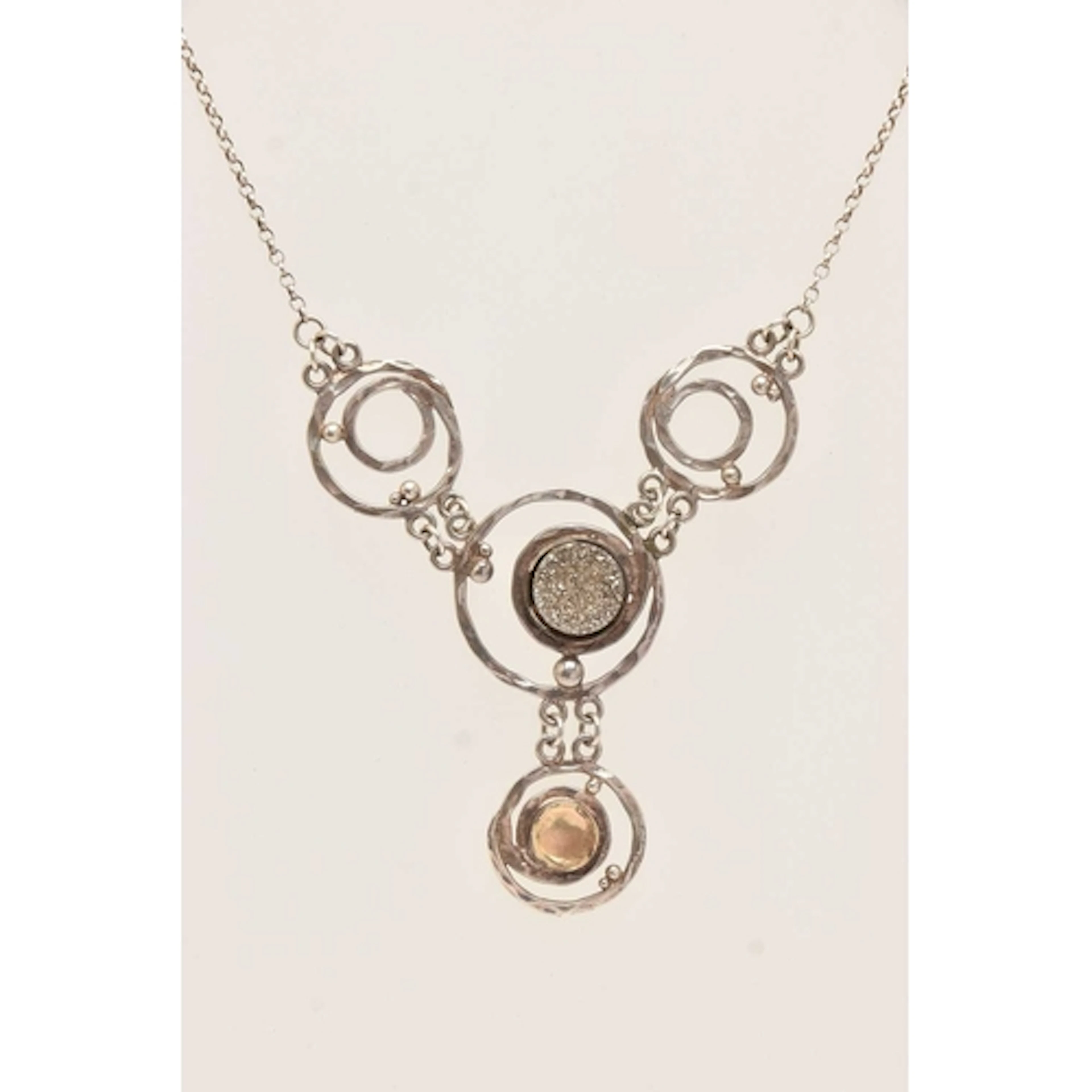 A WHITE METAL ABSTRACT PENDANT NECKLACE, circular open work ...