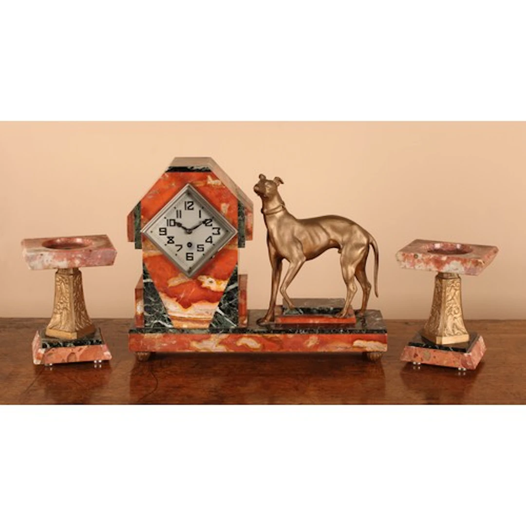 An Art Deco marble and cold painted spelter figural clock ga...