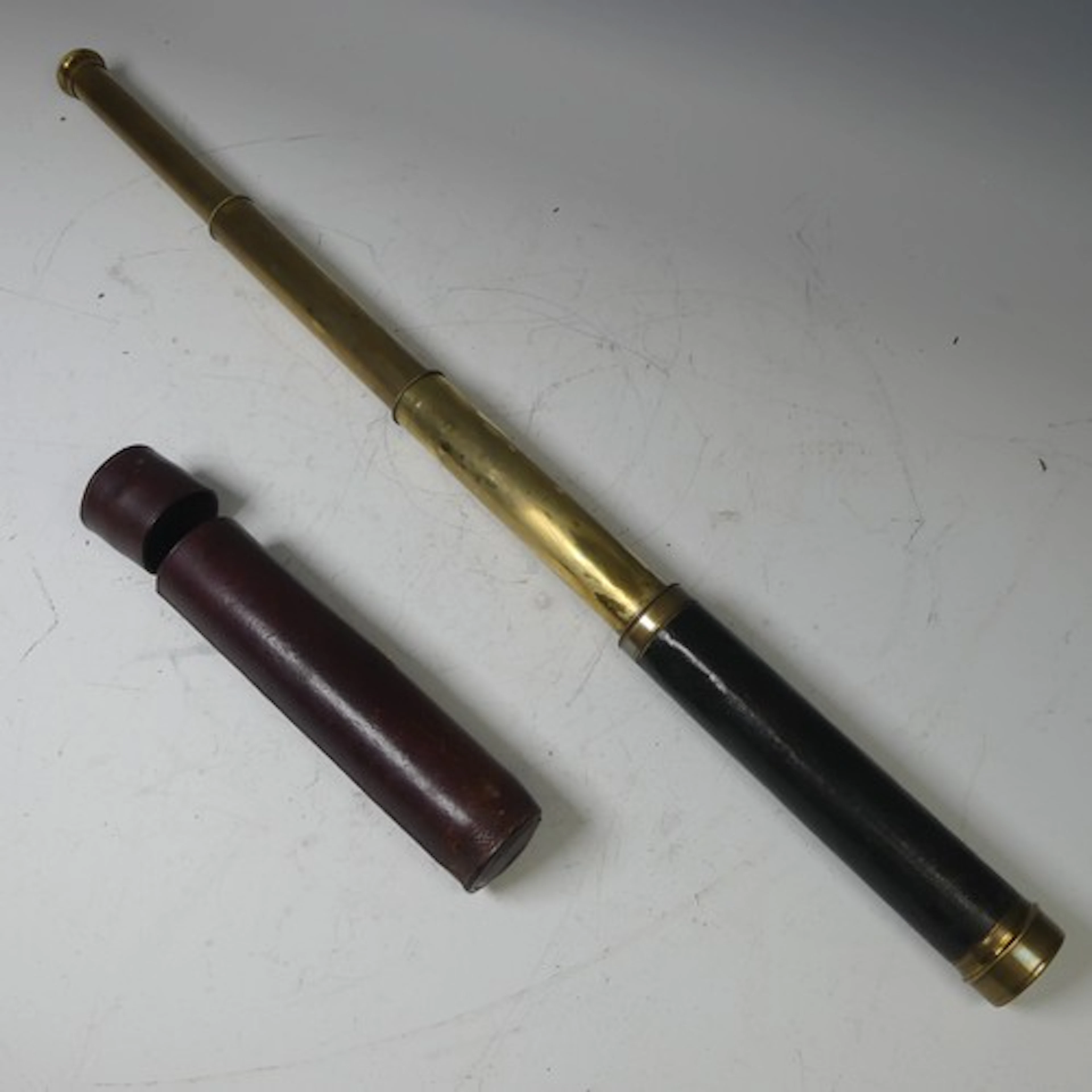 A late 19th/early 20th century brass and leather cased three...