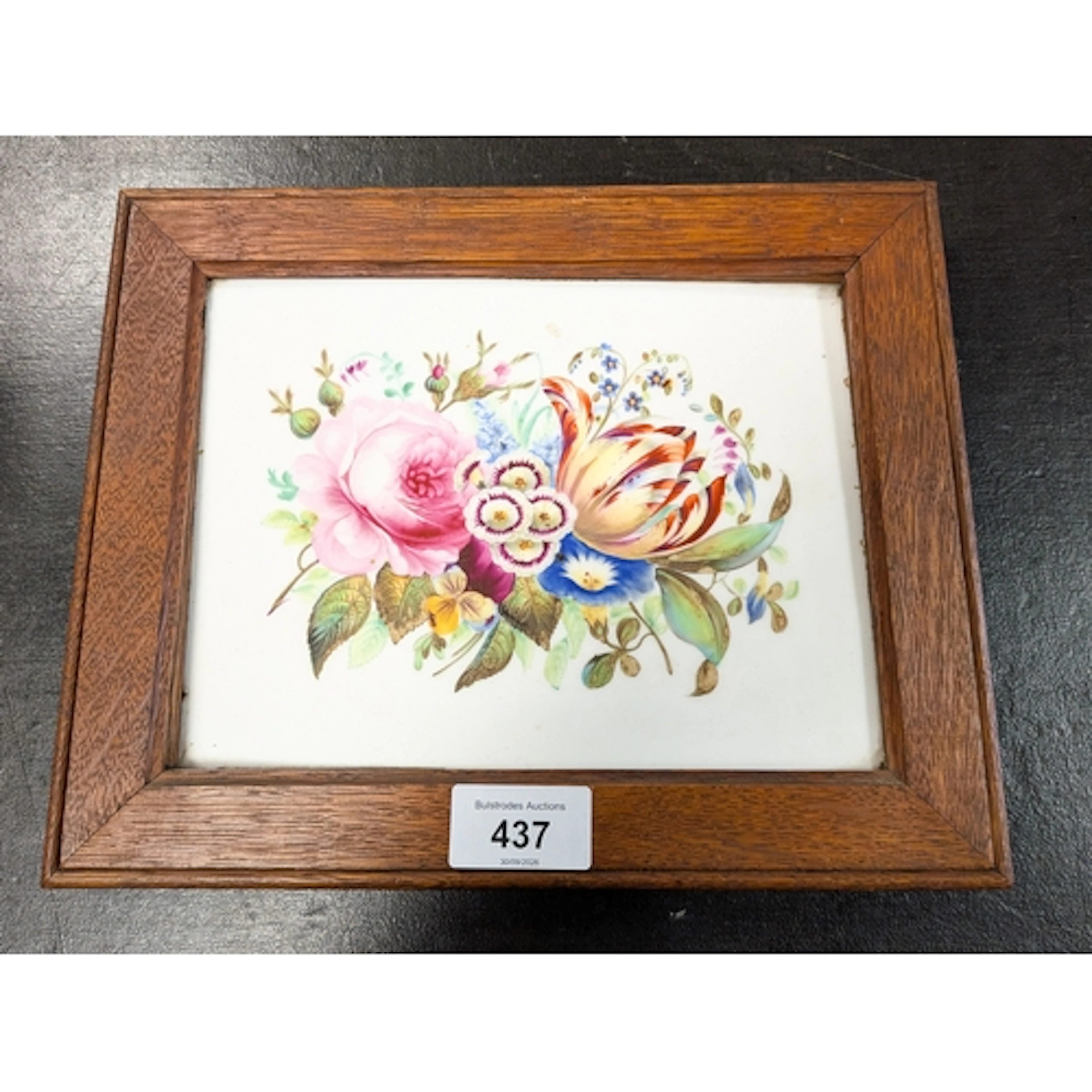 A 19th century hand painted ceramic tile, depicting a floral...