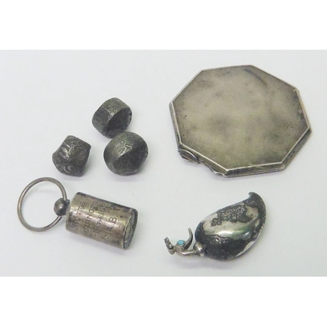 A Persian kohl bottle in the shape of a bird, white metal wi...