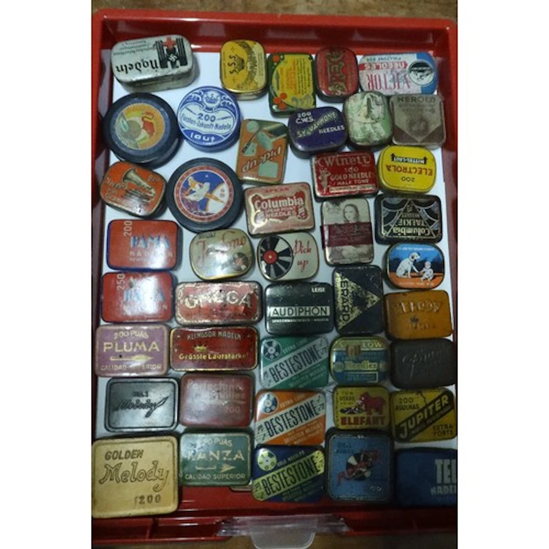 A tray of vintage gramophone needle tins