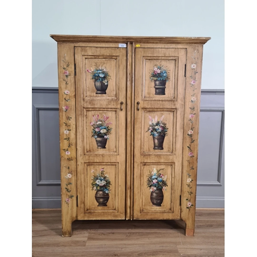 A hardwood panelled two door Cupboard decorated with flowers...
