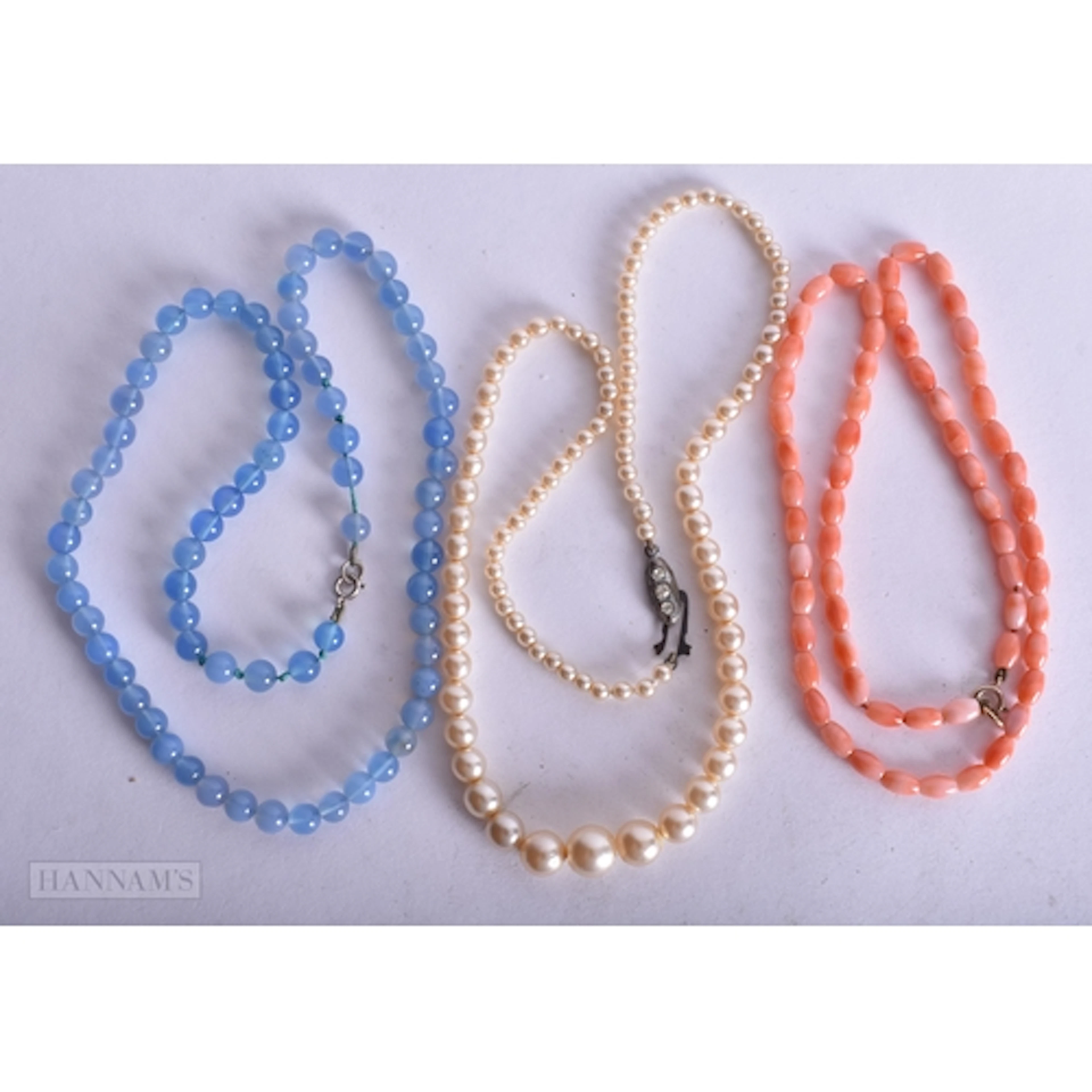 A CORAL NECKLACE and two others. Largest 50 cm long. (3)