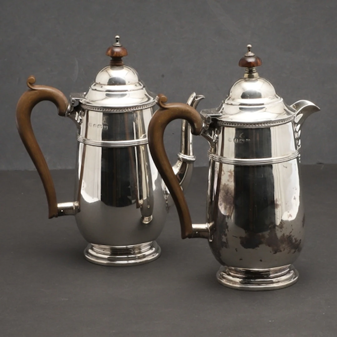 AN EARLY 20TH CENTURY SILVER CAFE AU LAIT PAIR. The lid topp...