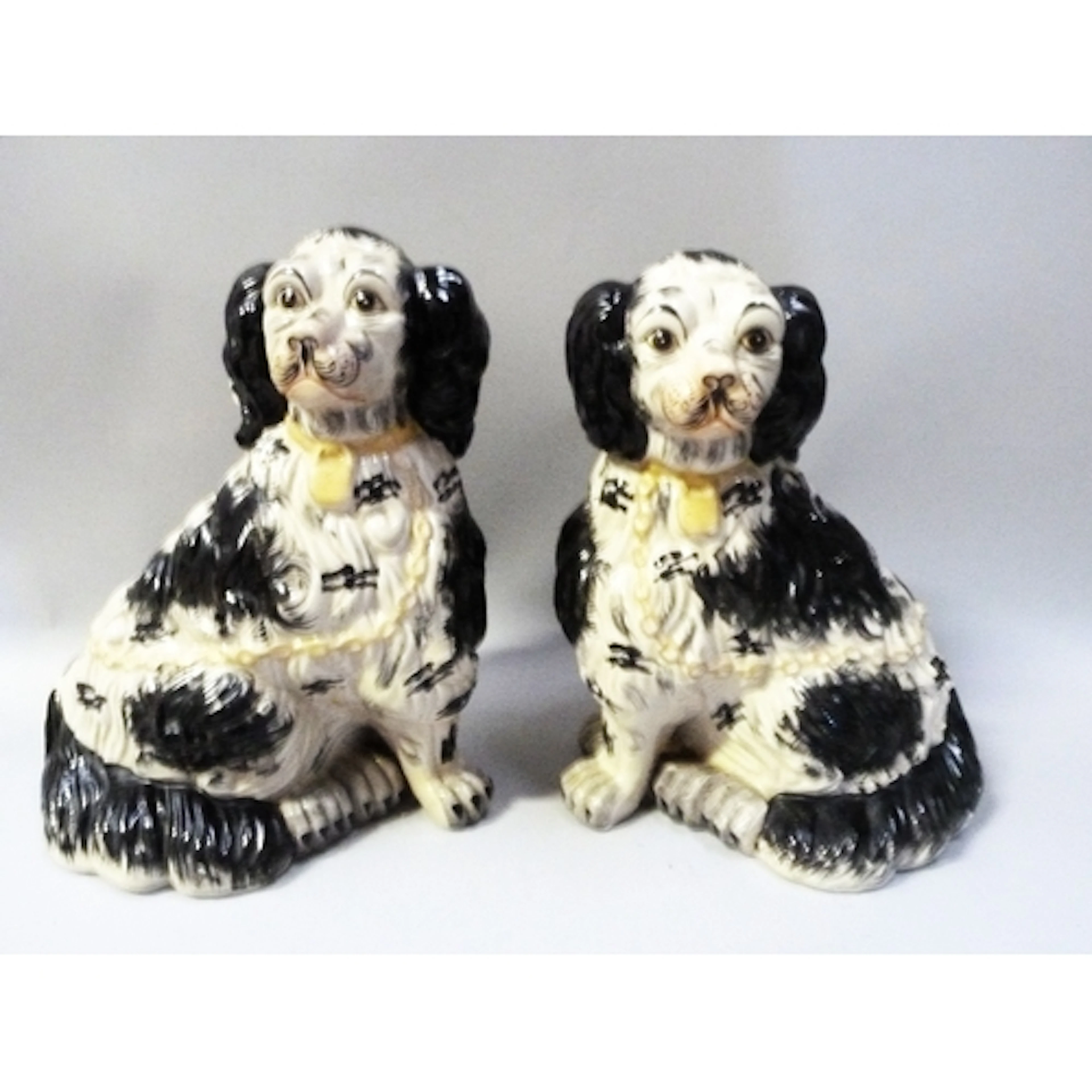 Pair of Staffordshire pottery mantel dogs modelled as a King...