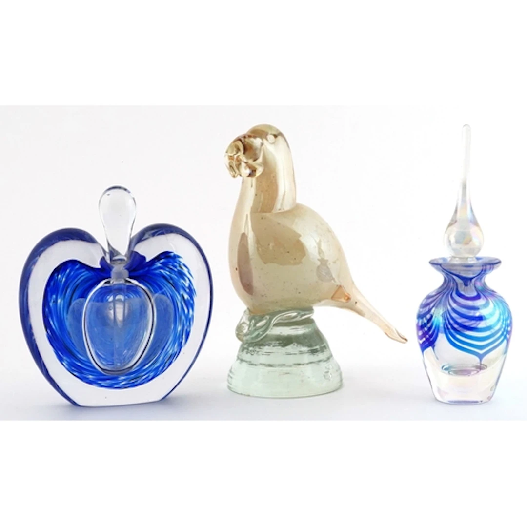 Three decorative glass items comprising two blue scent bottl...