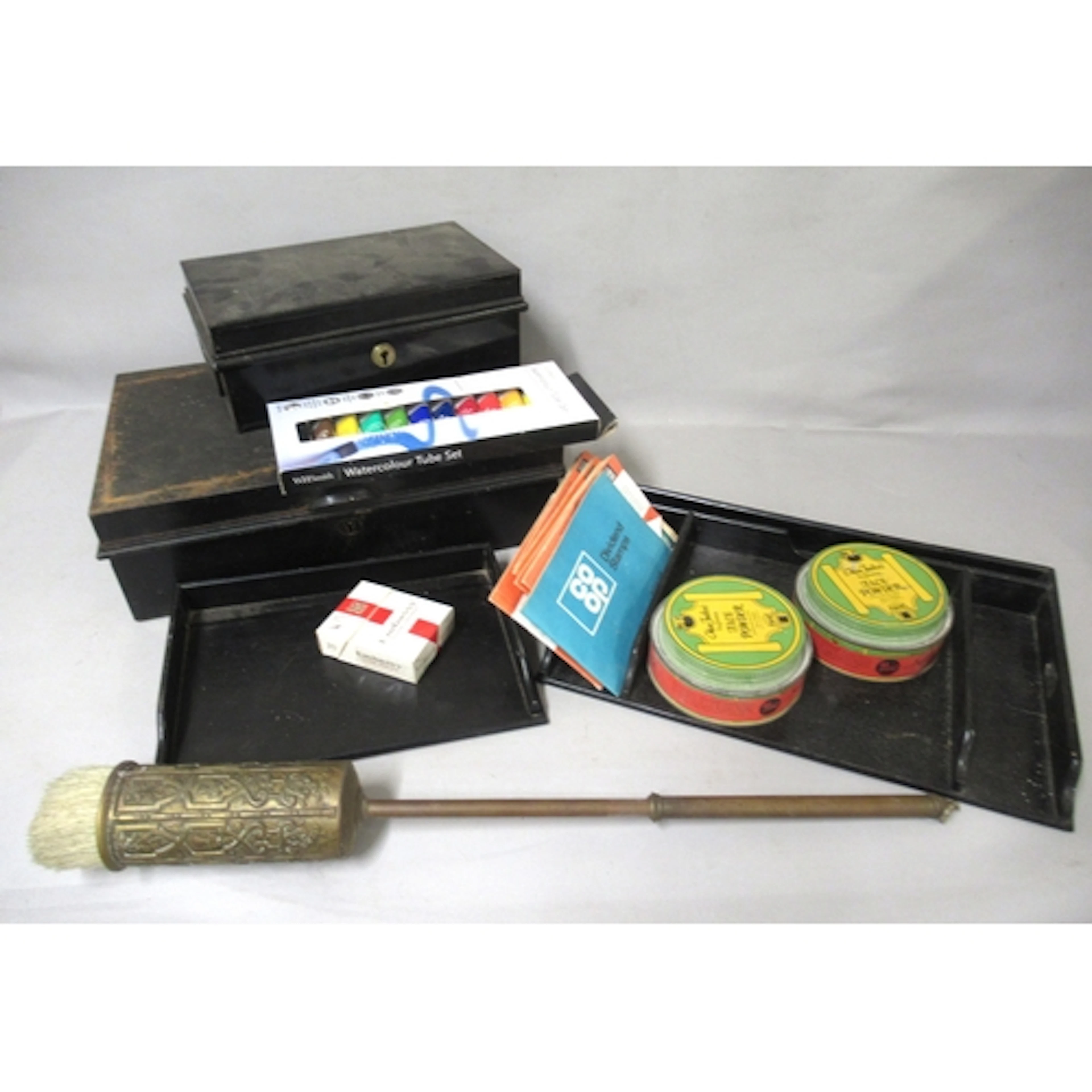 Two ebonised dressing table trays, two cash tins and a quant...