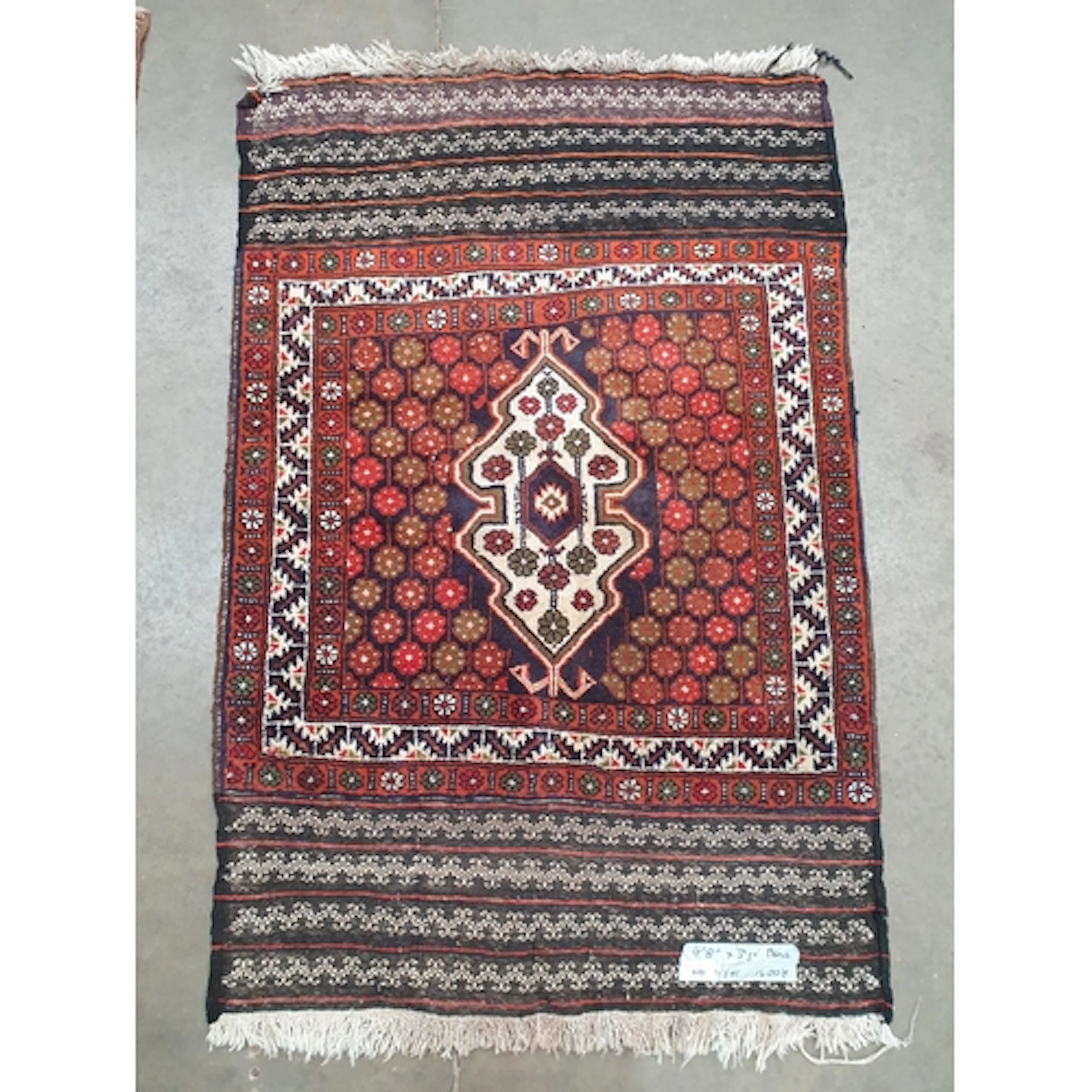 A Turkomen style Rug on blue and red ground, with stylised b...