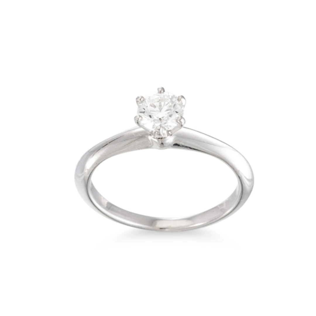 A DIAMOND SOLITAIRE RING, stamped Tiffany & Co., the brillia...