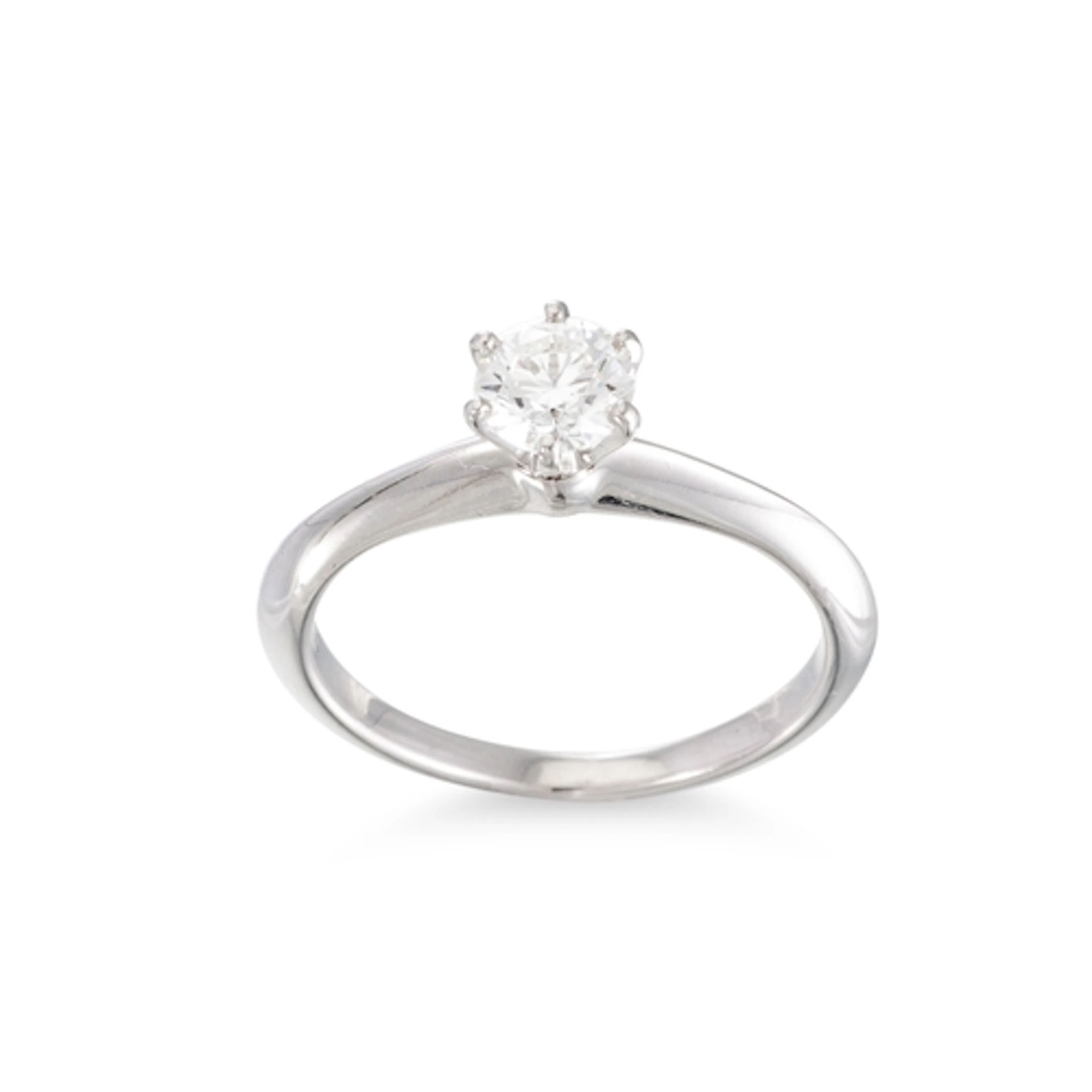 A DIAMOND SOLITAIRE RING, stamped Tiffany & Co., the brillia...